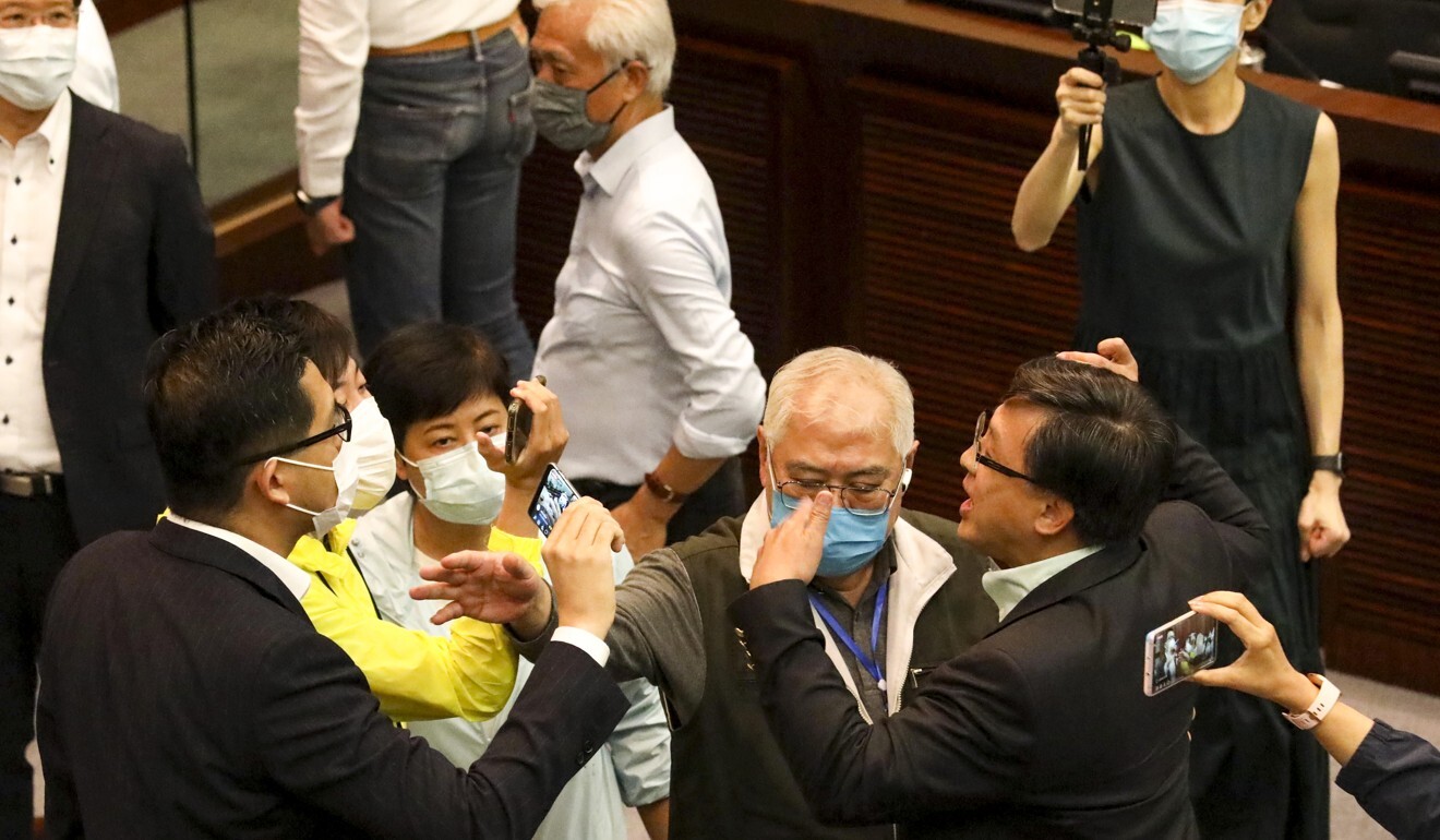 Legislative Council members jostle in the chamber on Friday. Photo: Dickson Lee