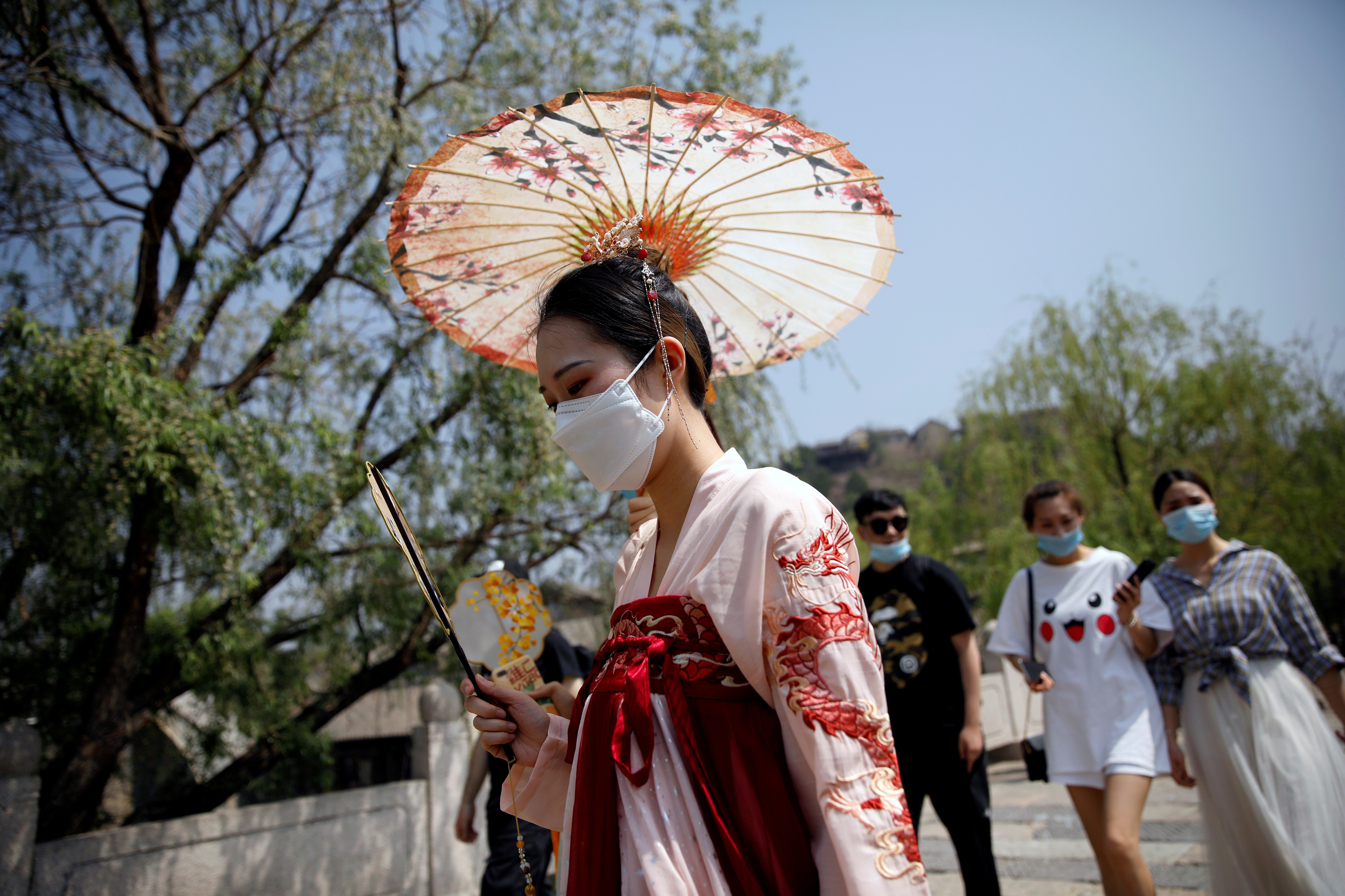 A woman wearing a face mask and traditional Chinese clothing visits Gubei Water Town on the first day of the five-day Labour Day holiday, on the outskirts of Beijing, on May 1. Domestic tourism offers opportunities for economies in recovery. Photo: Reuters