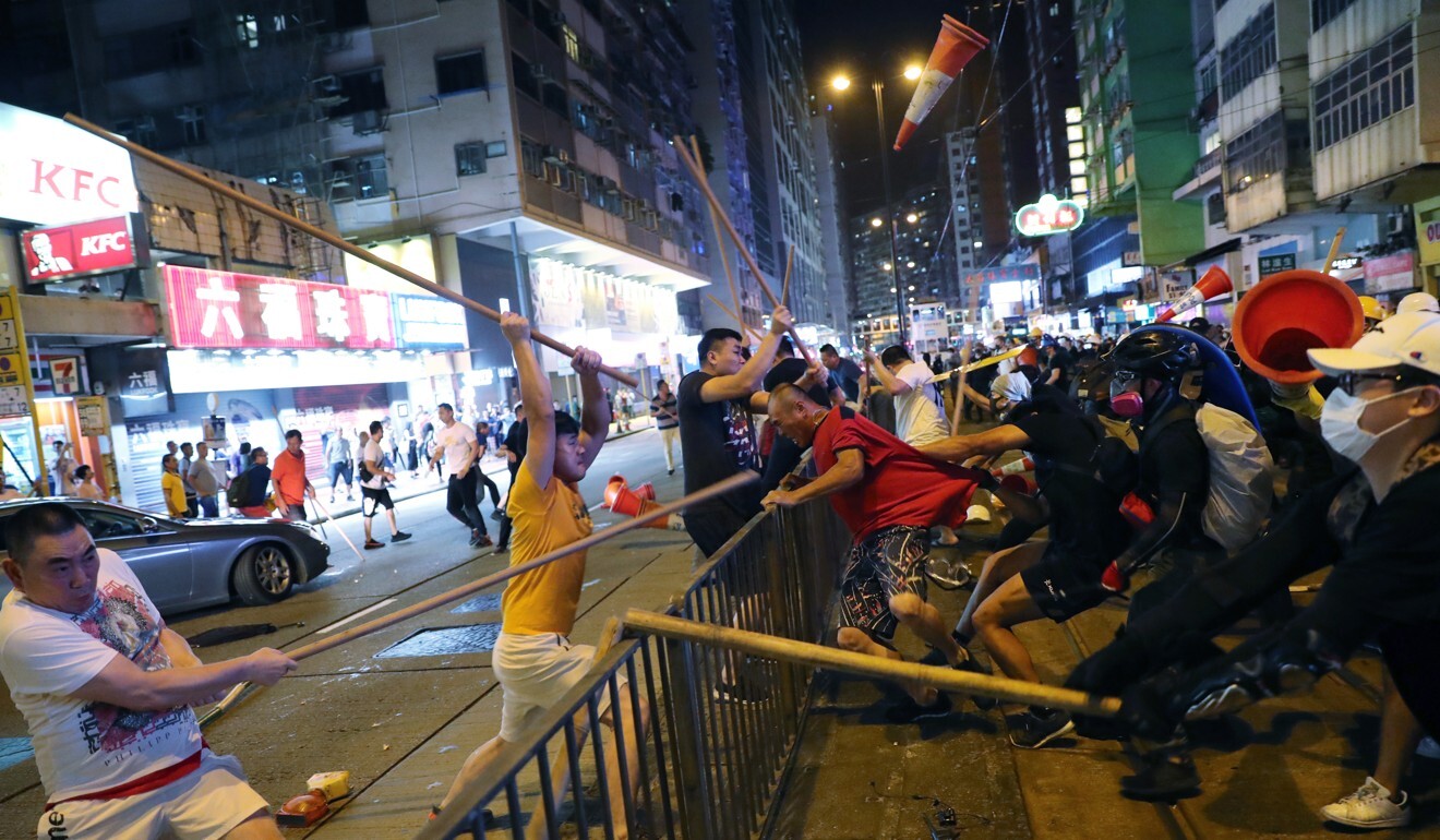 Men wielding bamboo poles attack protesters in Hong Kong’s North Point neighbourhood, an image captured by Post photographer Sam Tsang, who earned a third-place nod in the spot news category. Photo: Sam Tsang