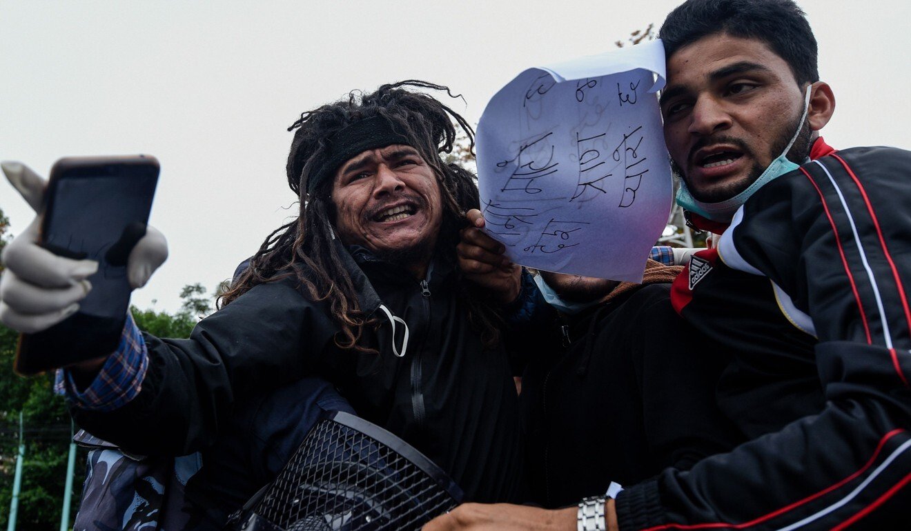 Police in Kathmandu on May 10, 2020 detain demonstrators during a protest against India’s new link road to the Chinese border. Photo: AFP
