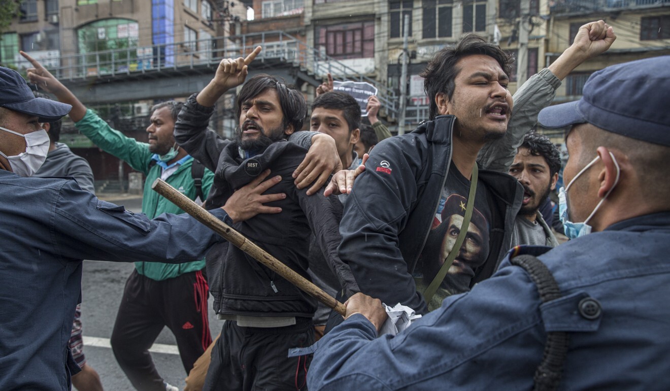 Nepalese police use batons stop demonstrators during a protest against the Indian government in front of Parliament Building in Kathmandu on May 10, 2020. Photo: EPA-EFE
