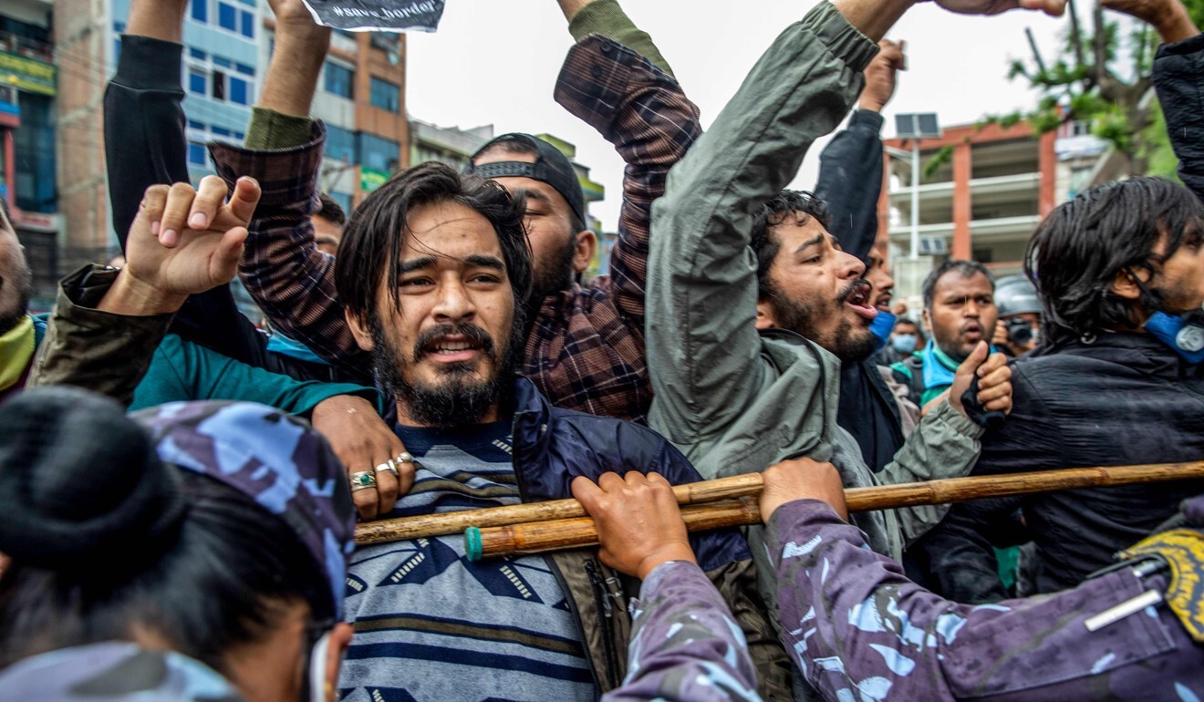 Police in Kathmandu on May 10, 2020 detain demonstrators during a protest against India’s new link road to the Chinese border. Photo: AFP