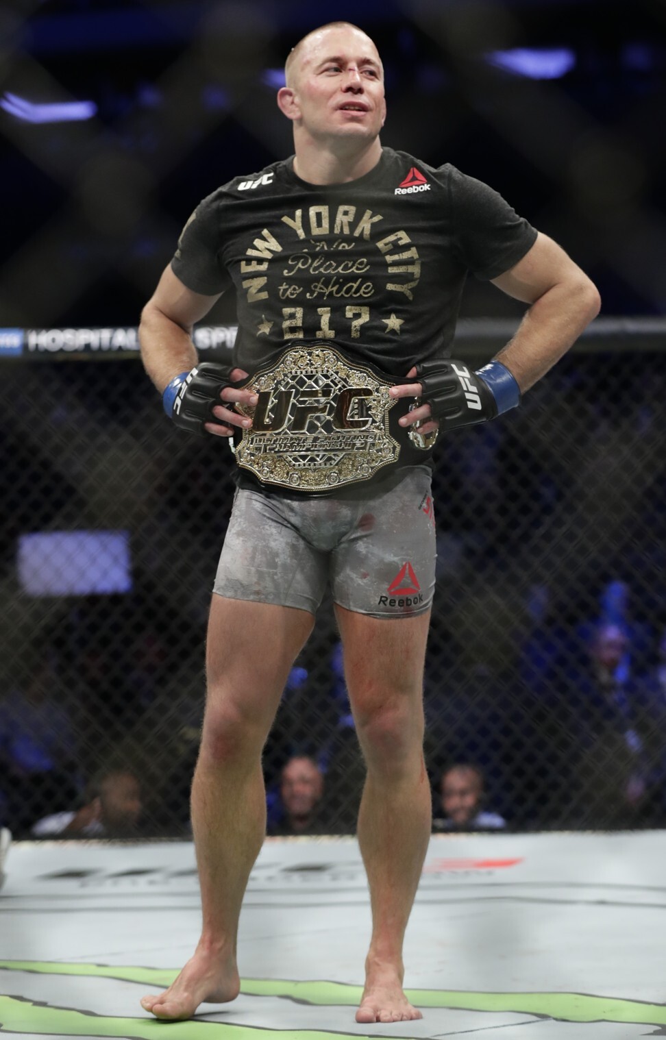 Georges St-Pierre celebrates dethroning Michael Bisping as middleweight champion. Photo: AP