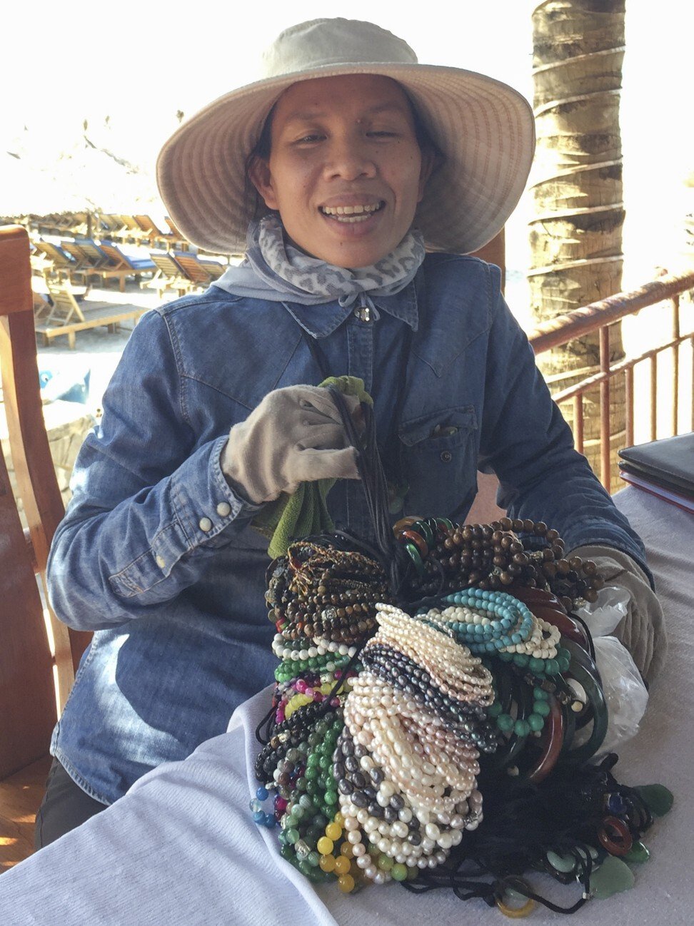 Bracelet seller Pham Thi Thu Xiem has returned to work at An Bang Beach in Hoi An. Photo: Patrick Scott