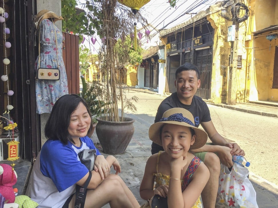 A family from Hanoi shops in mostly empty Hoi An Ancient Town. Photo: Patrick Scott