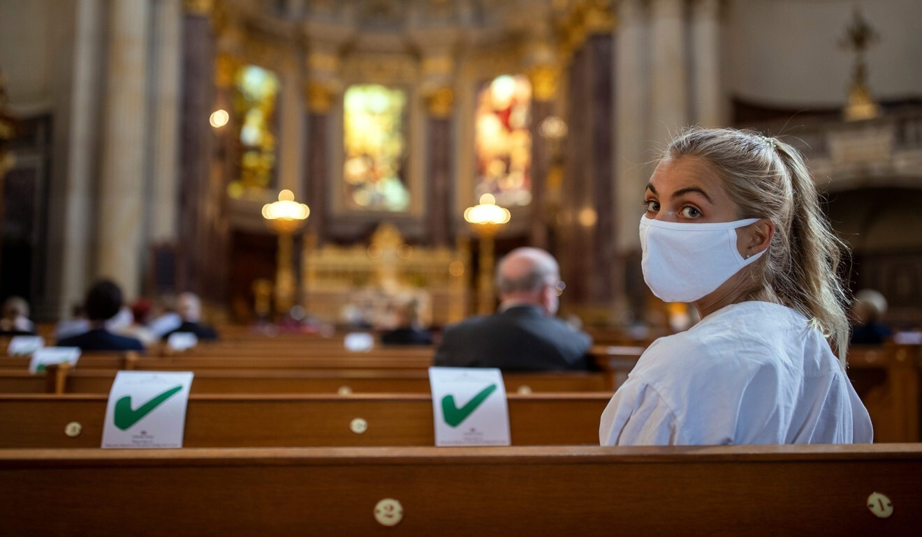 A woman wearing a protective face mask attends a Sunday service at the Berliner Dom cathedral in Berlin on Sunday. Photo: AFP
