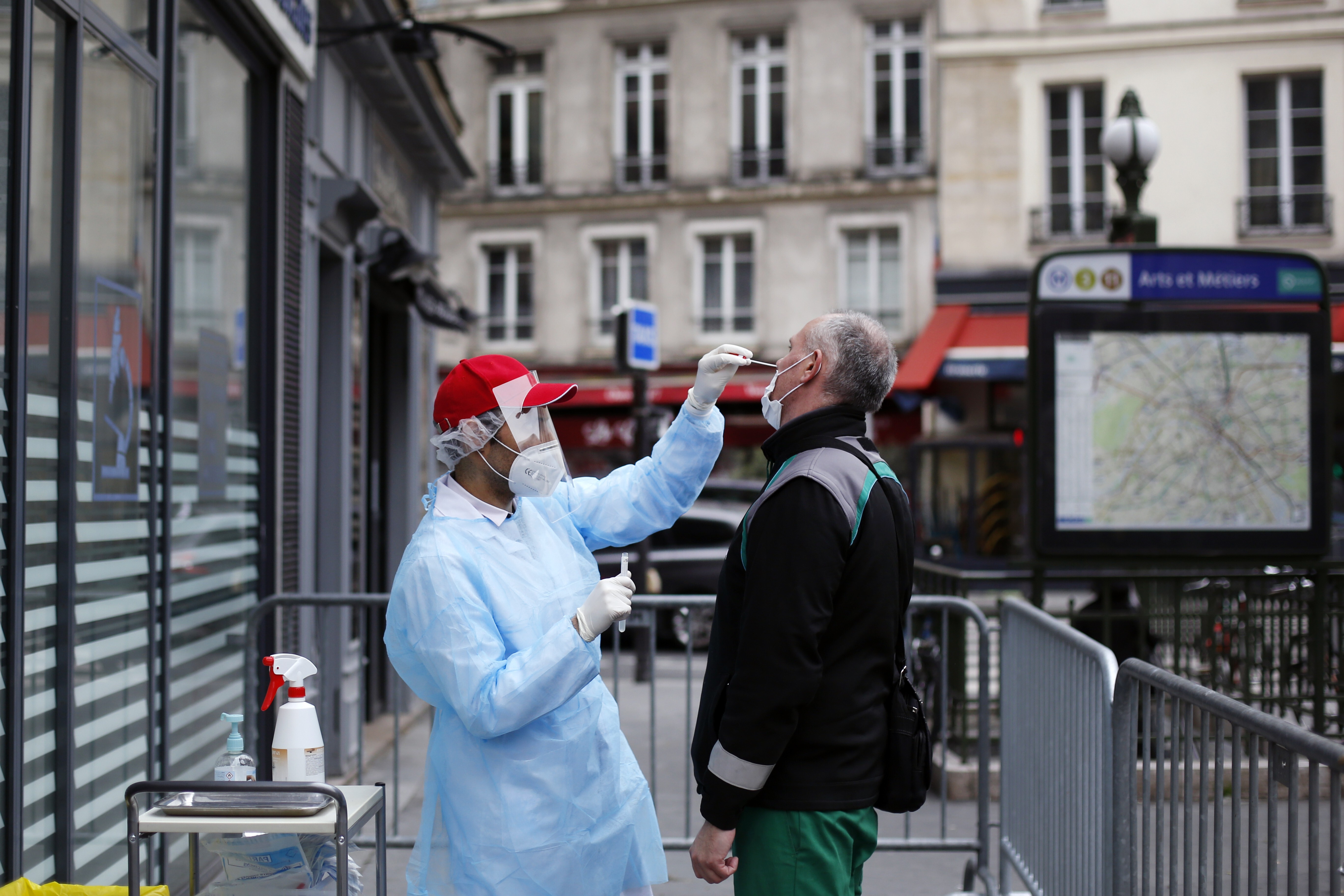 A health worker collects a nasal swab sample from a man to test for the coronavirus in Paris, as France cautiously eases its two-month lockdown. Photo: AP