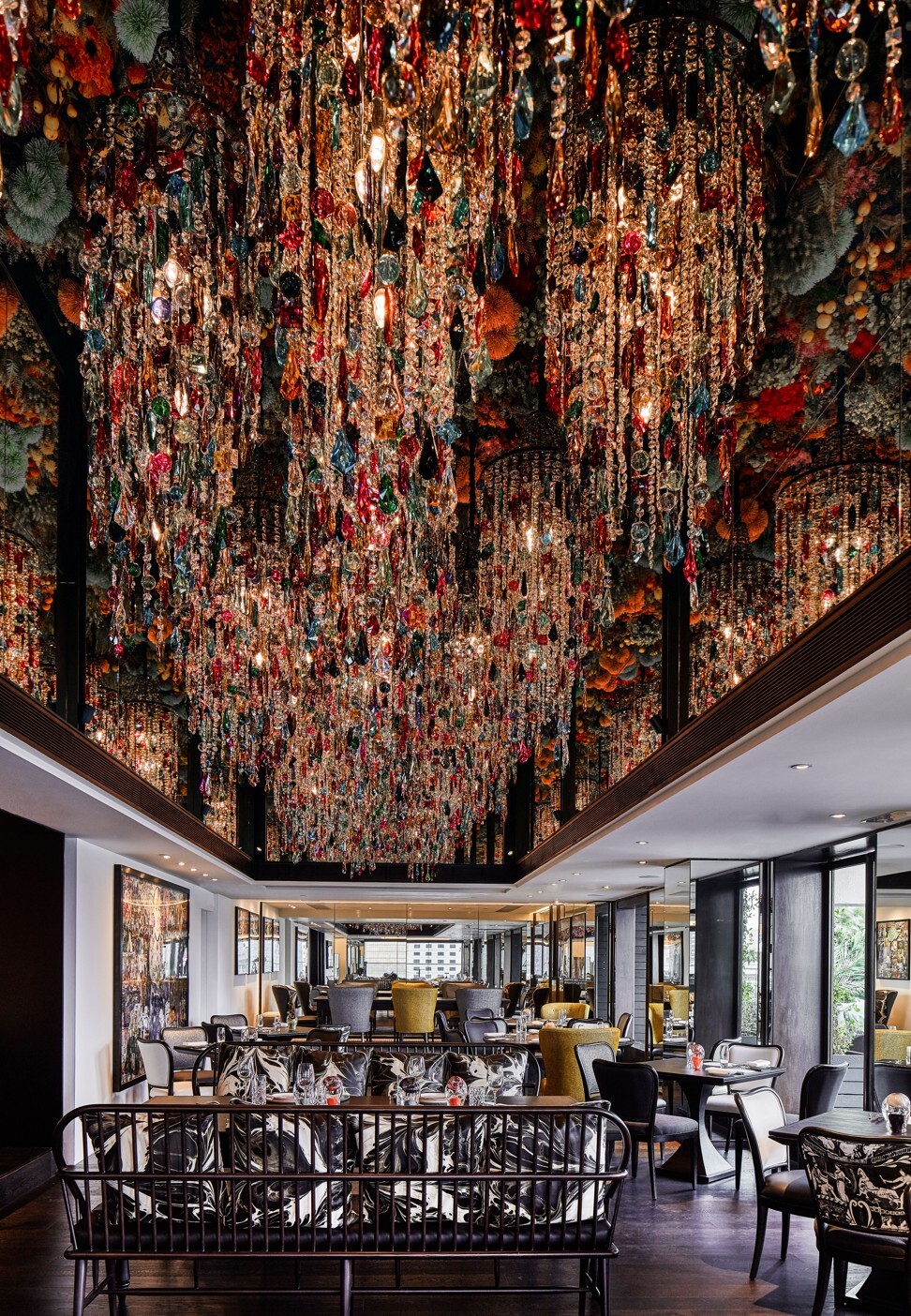 The ceiling installation consists of 100,000 silk flowers and 36 custom-made gypsy chandeliers with more than 76,000 handcrafted crystals.