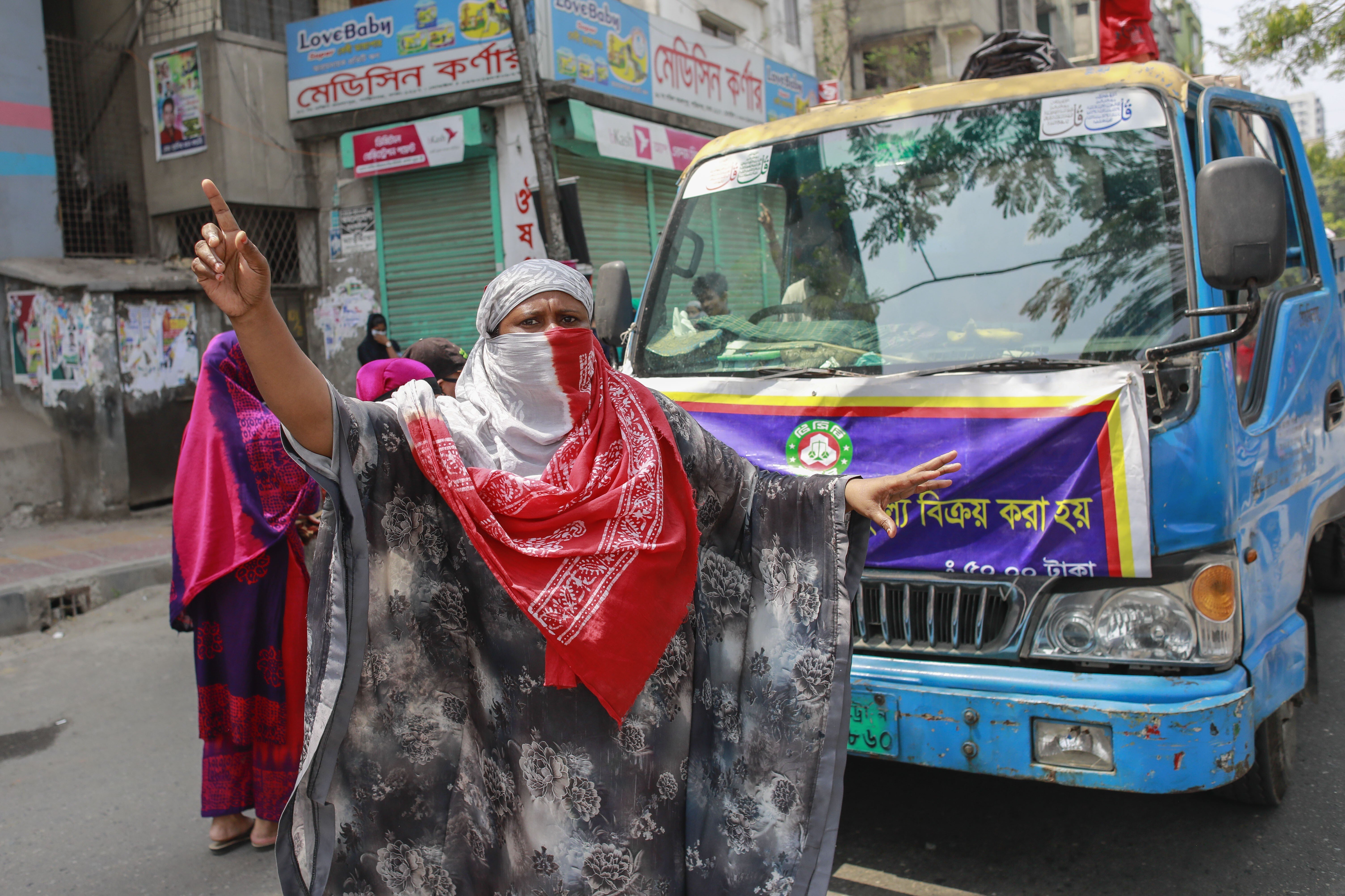 Bangladeshi garment workers block a road during a demanding their wages amid the coronavirus crisis.