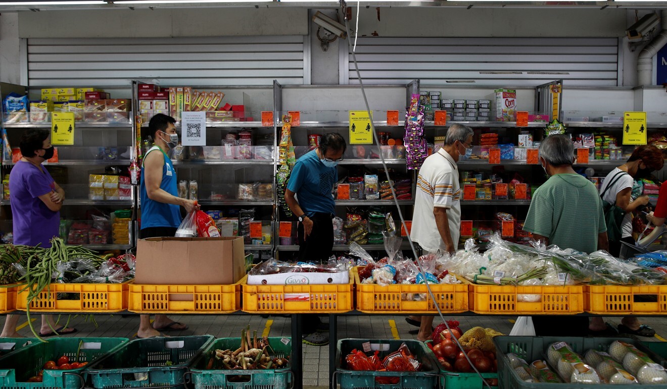 People queue up outside a grocery shop in Singapore on May 12, 2020. Photo: Reuters