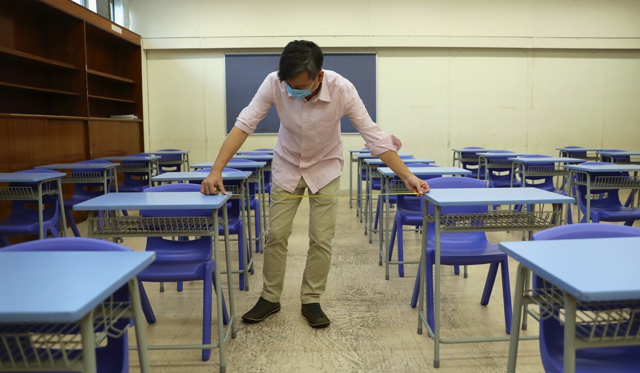 Chow Sau-leuk, vice-principal at CMA Secondary School, checks the spacing between desks. Photo: Winson Wong