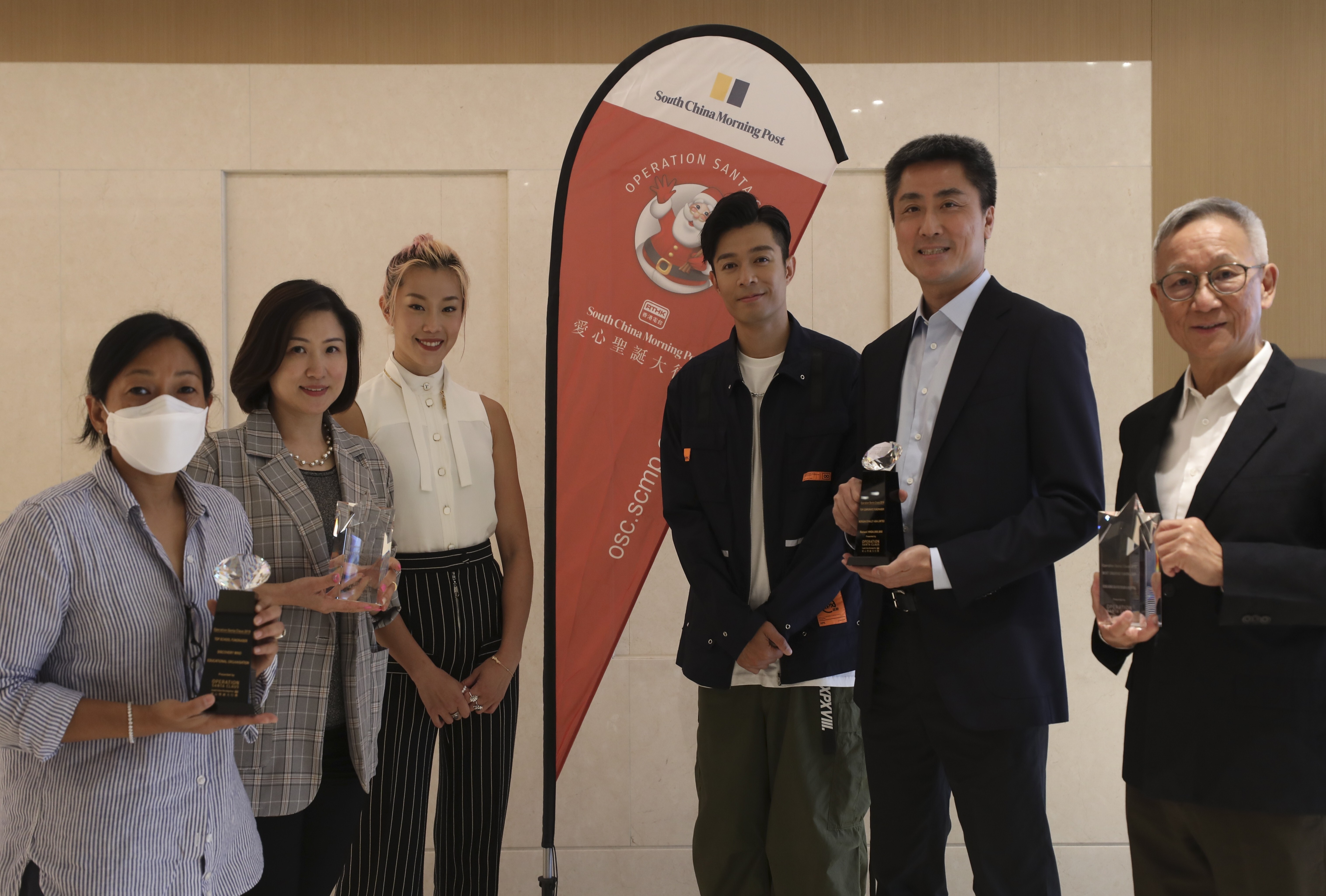 (From left) Kabeeta Gurung, of the Discovery Mind International Play Centre; Angela Yip, of Shung Tak Catholic English College’s Parent Teacher Association; Olympic swimmer and Operation Santa Claus (OSC) ambassador Stephanie Au; Canto-pop singer Chau Pak-ho; Morgan Stanley community affairs chief Kwok-Choi Wong and Dr Joseph Chan attend the May 13 OSC award ceremony in Shau Kei Wan. Photo: Xiaomei Chen