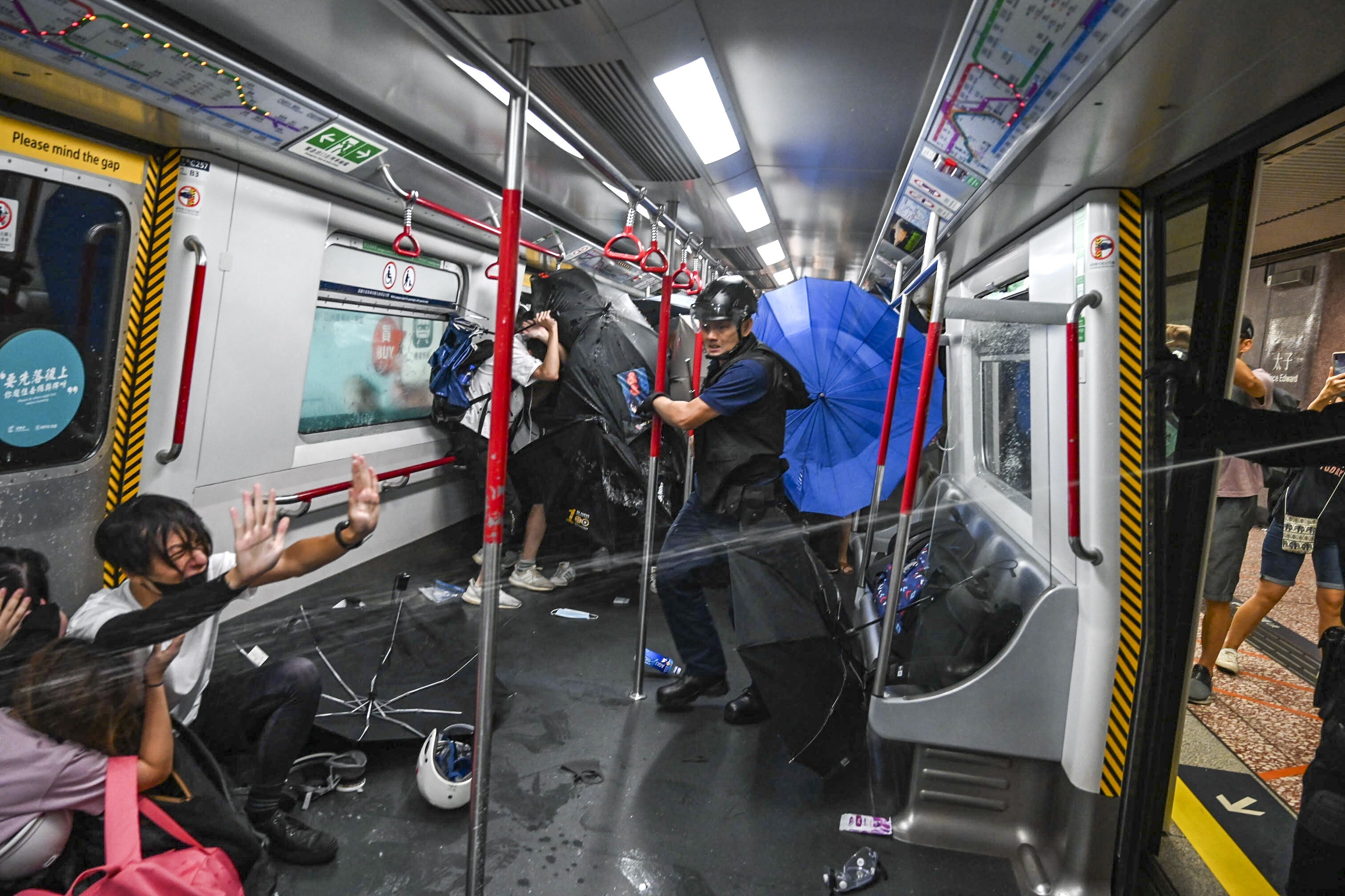 Police use force on people inside an MTR train at Prince Edward station in August. Photo: Handout