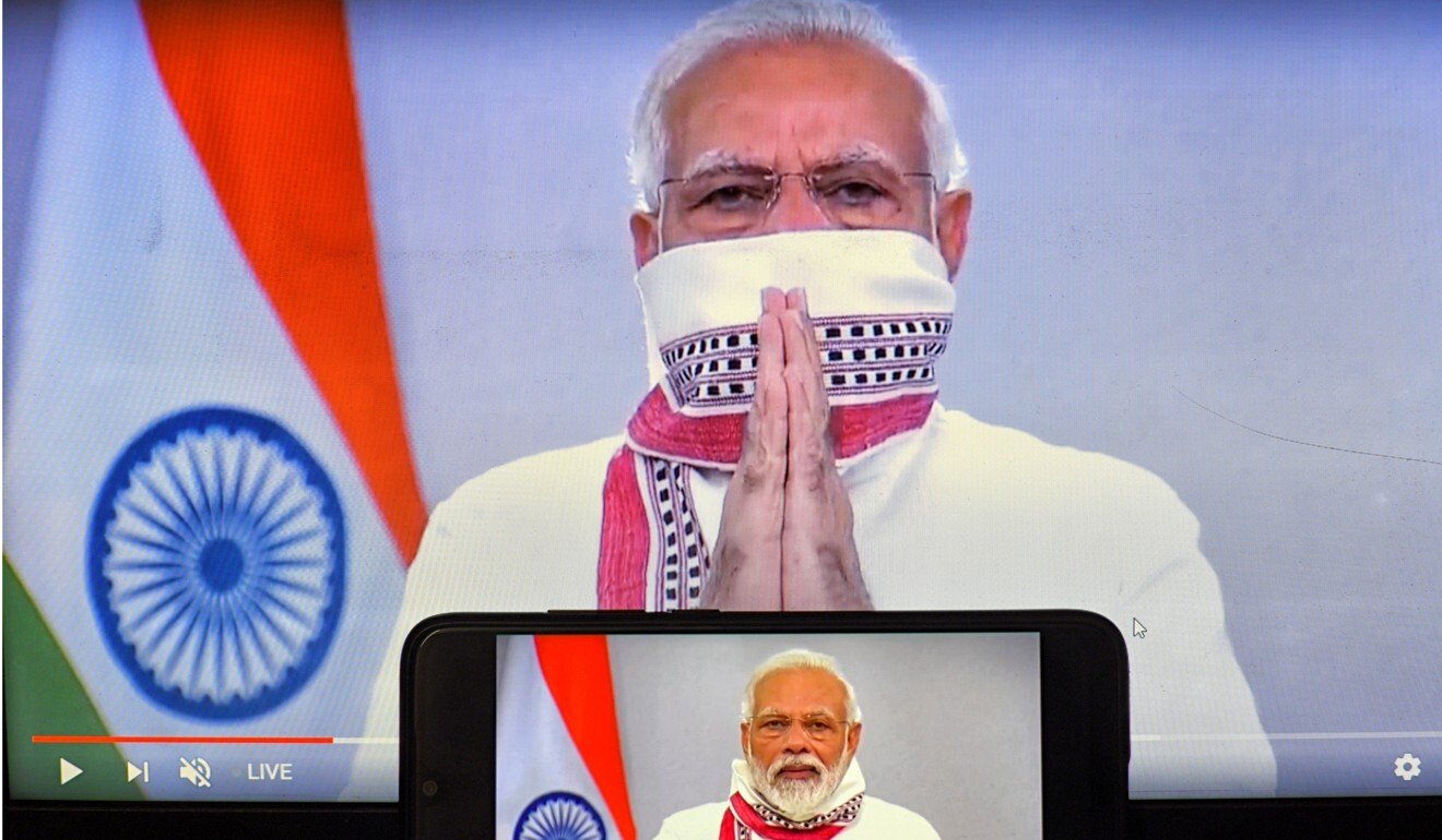 Indian Prime Minister Narendra Modi is seen on a smartphone and a screen during one of his televised addresses. Photo: DPA