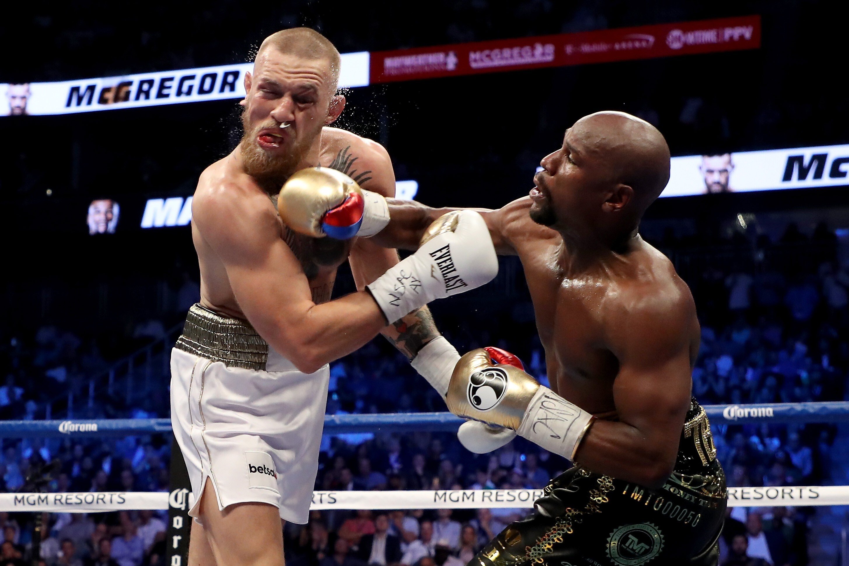 Floyd Mayweather throws a punch at Conor McGregor. Photo: AFP