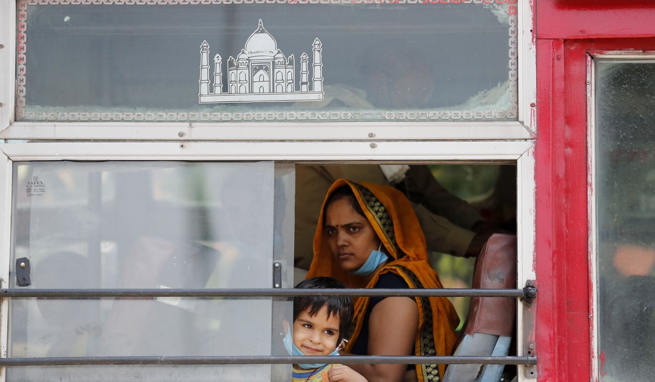 A migrant labourer, who arrived from Gujarat state on a train, inside a bus leaving for her native village in Uttar Pradesh, India. Photo: AP