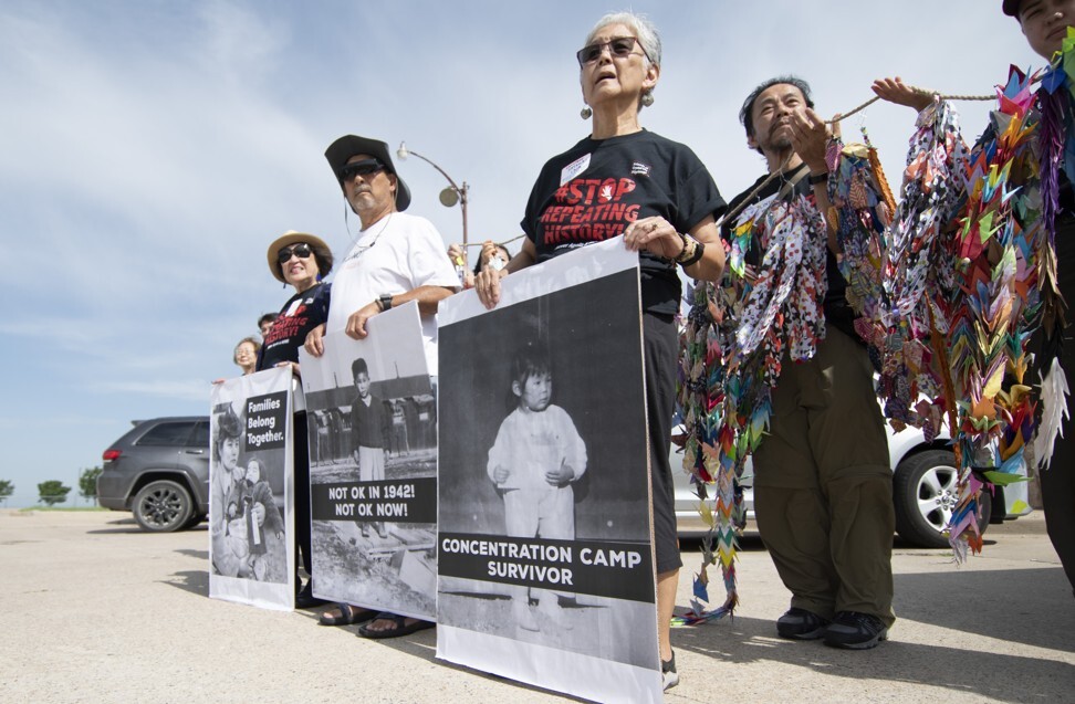 Satsuki Ina (holding sign, right) was born in a concentration camp for Japanese-Americans during World War II. Photo: AFP
