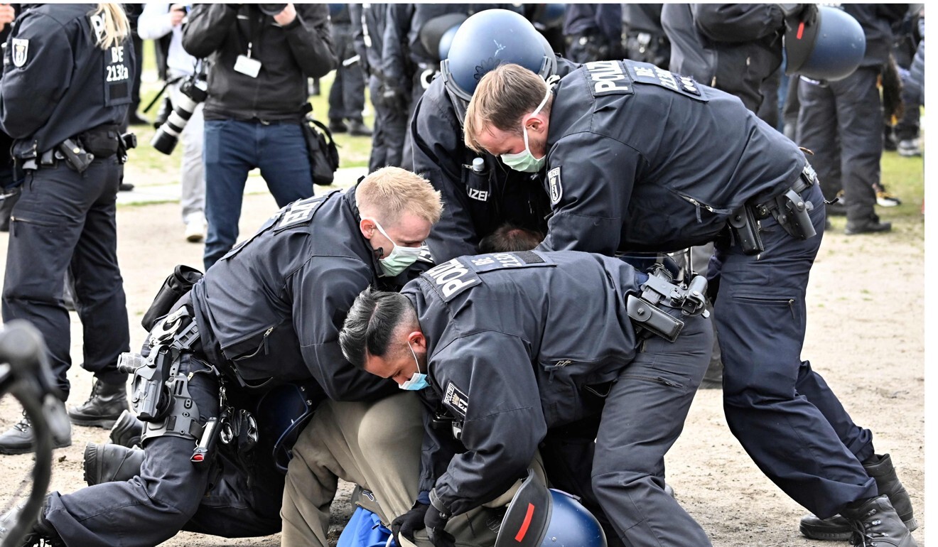 Police arrest a man who attended a protest in Berlin. Photo: AFP