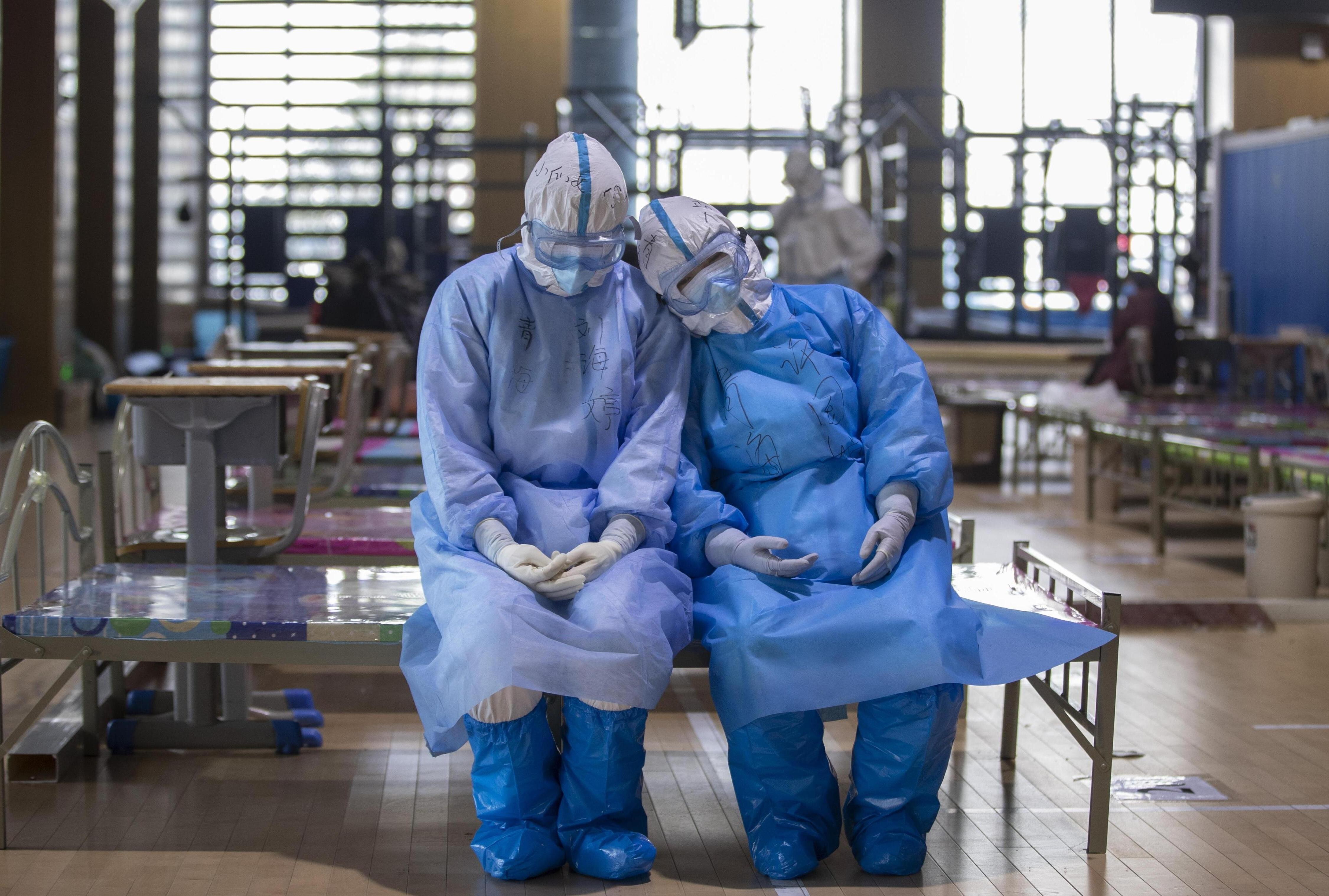 Two medical workers from northwest China’s Qinghai province take a rest before leaving the Wuchang temporary hospital in Wuhan, in central China’s Hubei province, on March 10. Photo: Xinhua