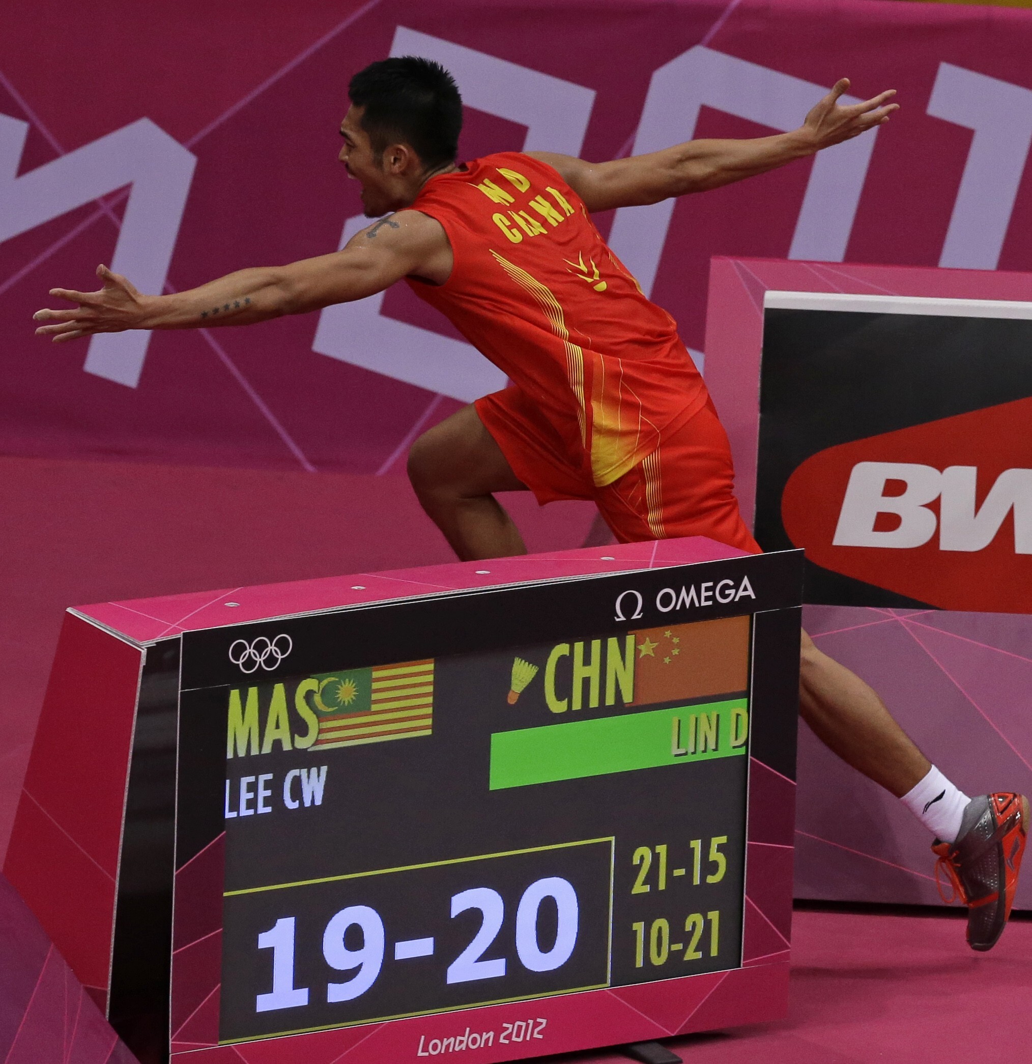 Lin Dan runs past the scoreboard and away from the court while celebrating his victory against Lee Chong Wei in the men's singles final at the 2012 London Olympic Games. Photo: AP