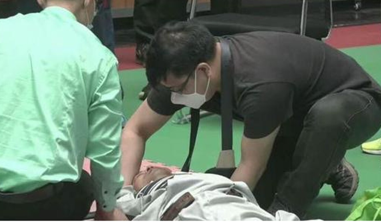 Ma Baoguo gets tended to by medical staff after getting knocked out. Photo: YouTube