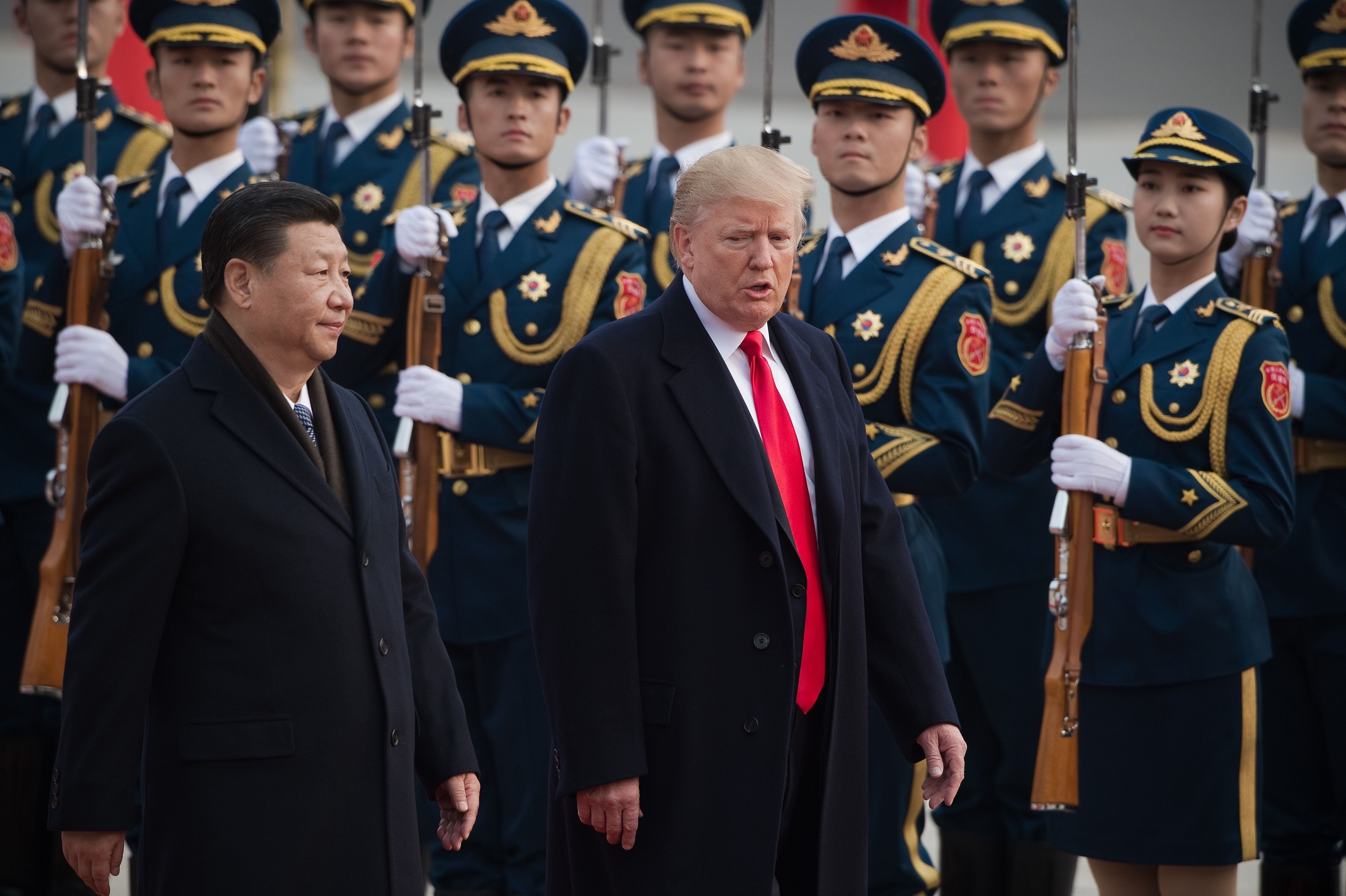 Chinese President Xi Jinping (left) and US President Donald Trump review an honour guard during a welcome ceremony at the Great Hall of the People in Beijing on November 9, 2017. Photo: AFP