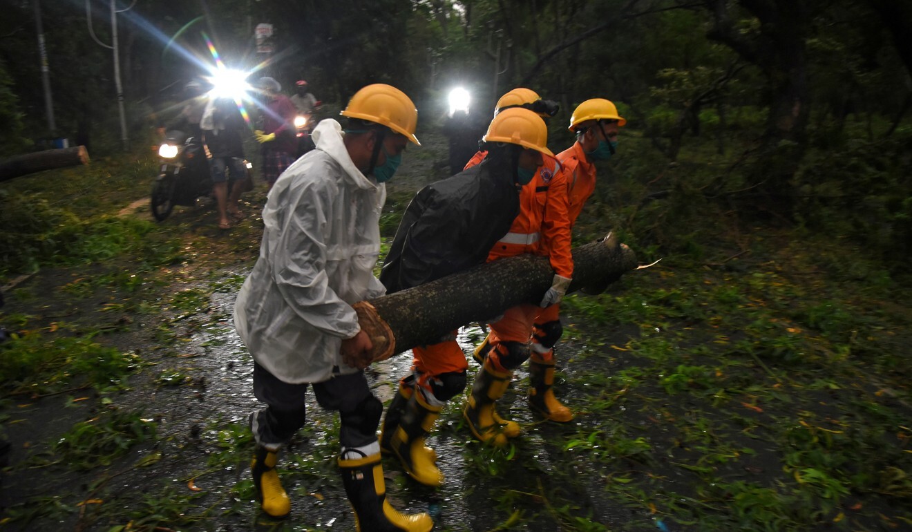 National Disaster Rescue Force members remove a branch of an uprooted tree after Cyclone Amphan made landfall in Digha, India on Wednesday. Photo: Reuters