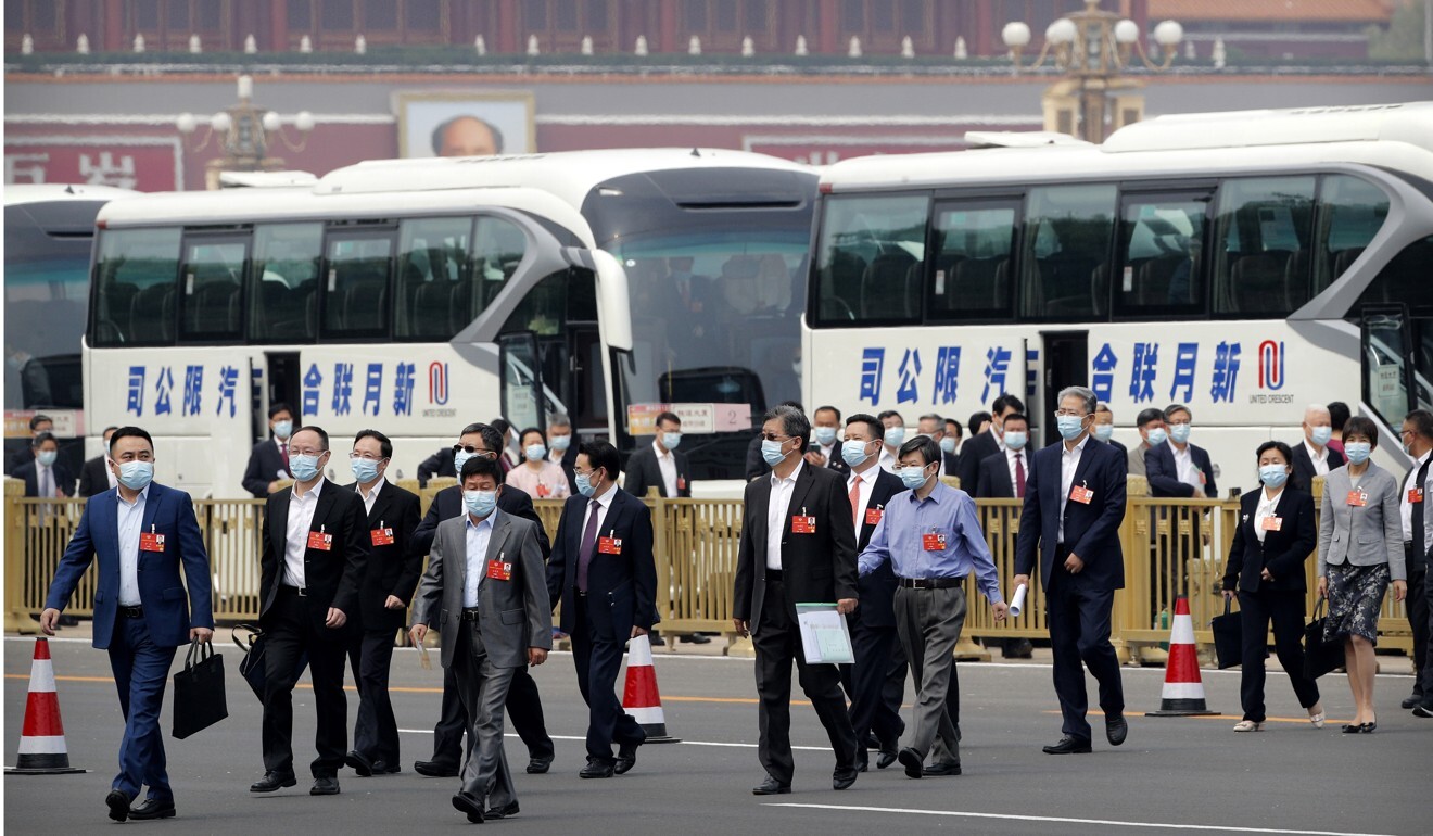 Delegates wearing face masks arrive for the start of the “two sessions”. Photo: AP