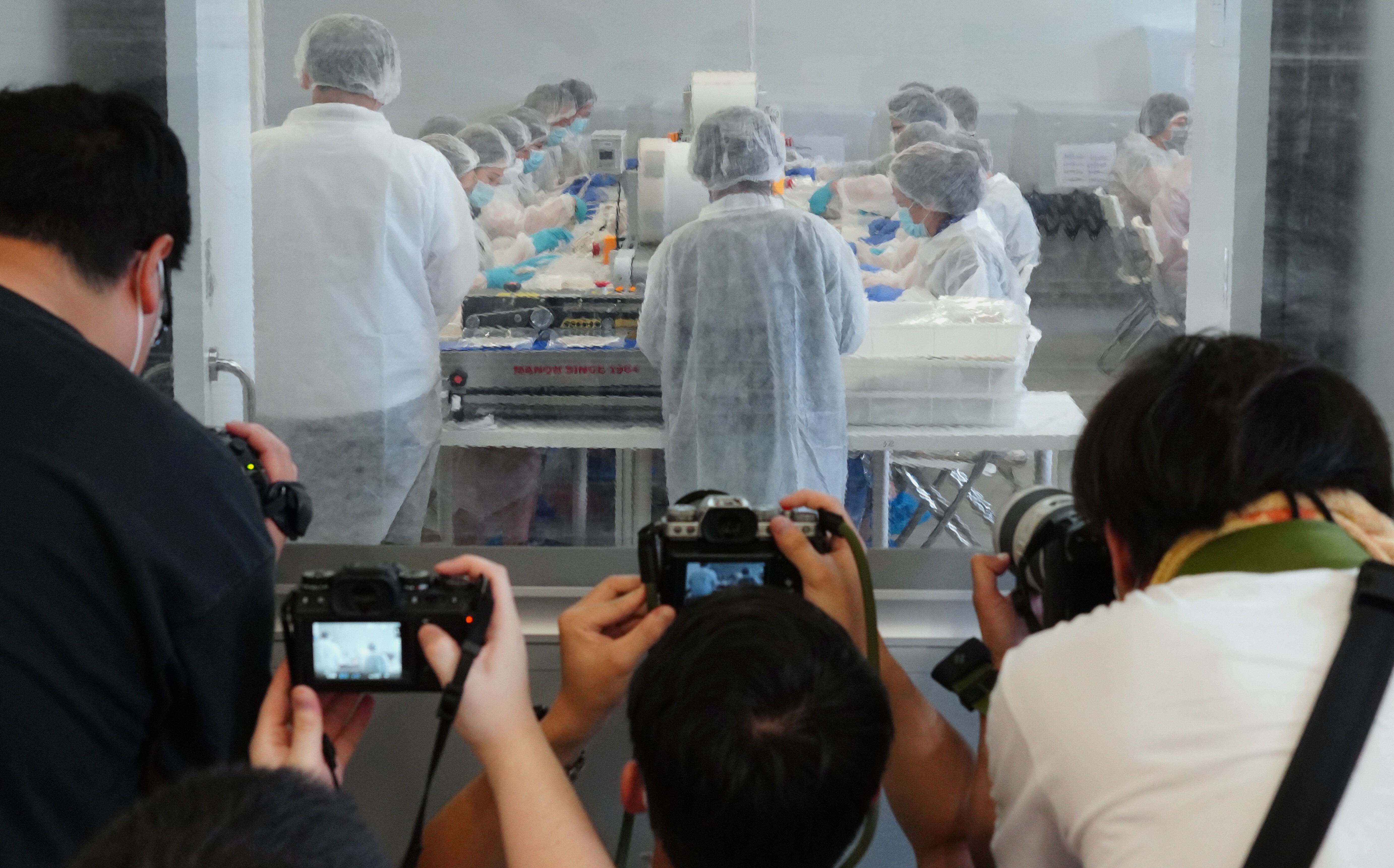 A media tour of Novetex Textiles in Tai Po, Hong Kong, gives photojournalists a glimpse of the production of CuMask+. Most of the masks are being made at a facility in Vietnam, while the the rest are assembled, disinfected and packed at three local facilities, including Novetex Textiles. Photo: Robert Ng