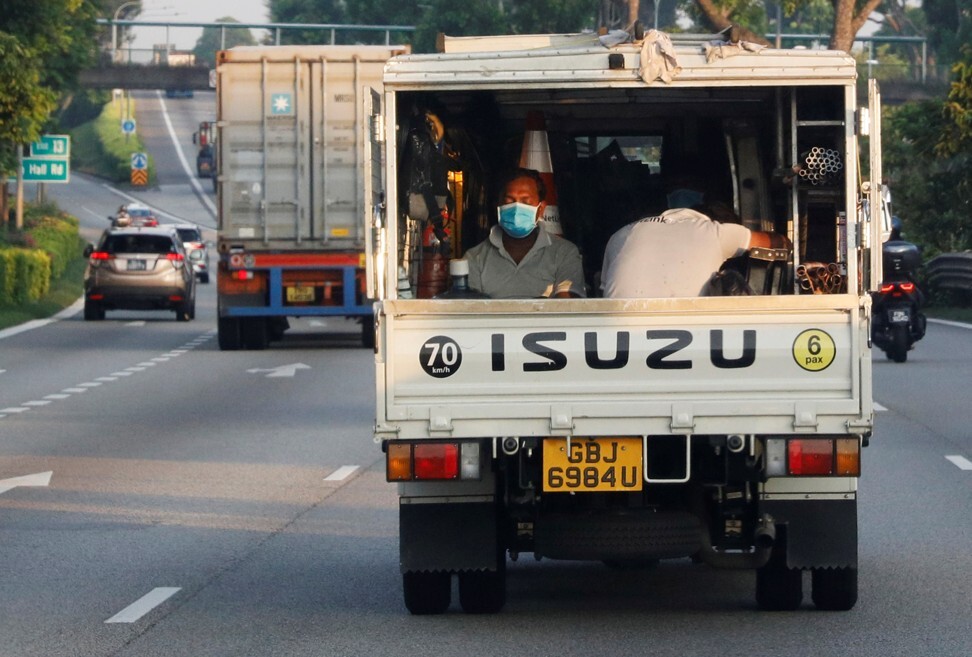 Workers ride at the back of a lorry in Singapore on May 15, 2020. Photo: Reuters