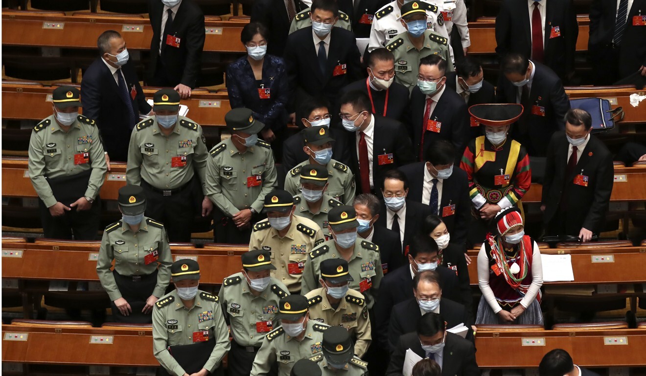 Military delegates leave after the opening session of the National People’s Congress at the Great Hall of the People in Beijing on Friday. Photo: AP