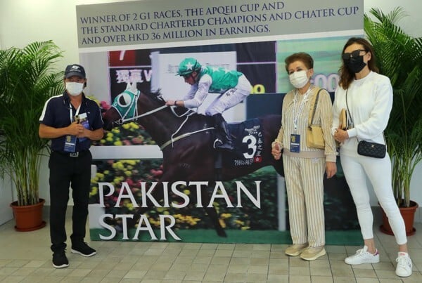 Tony Cruz, Kerm Din’s wife and Paulene Cruz stand in front of a poster of Pakistan Star.