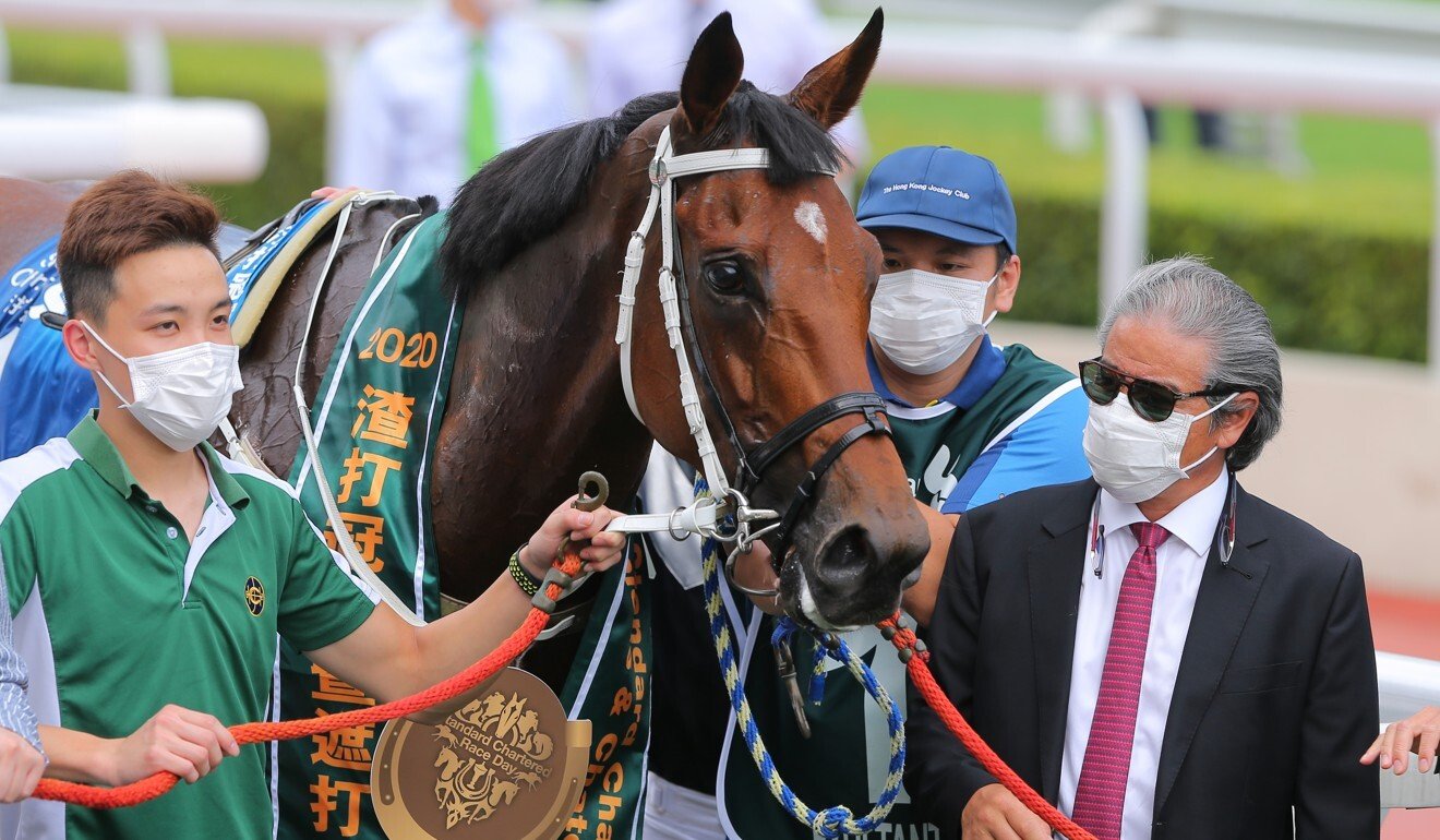 Tony Cruz looks over Exultant after winning the Group One Standard Chartered Champions & Chater Cup.