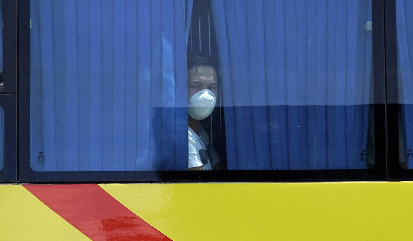 An OFW looks out from inside a bus during his repatriation in Cebu City on Friday. Photo: EPA