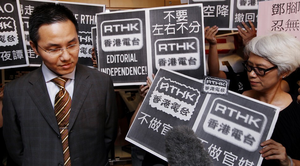 RTHK staff dressed in black wave placards to “receive” the new director of broadcasting, Roy Tang Yun-kwong, on September 15, 2011, as he arrives to start work at the broadcaster’s headquarters in Kowloon Tong. Photo: Handout