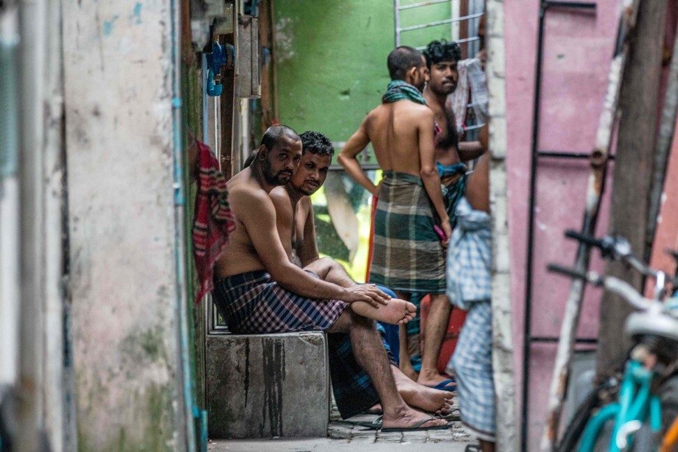 Foreign workers gather in an alleyway of an accommodation block in Male on May 9, 2020. Photo: AFP