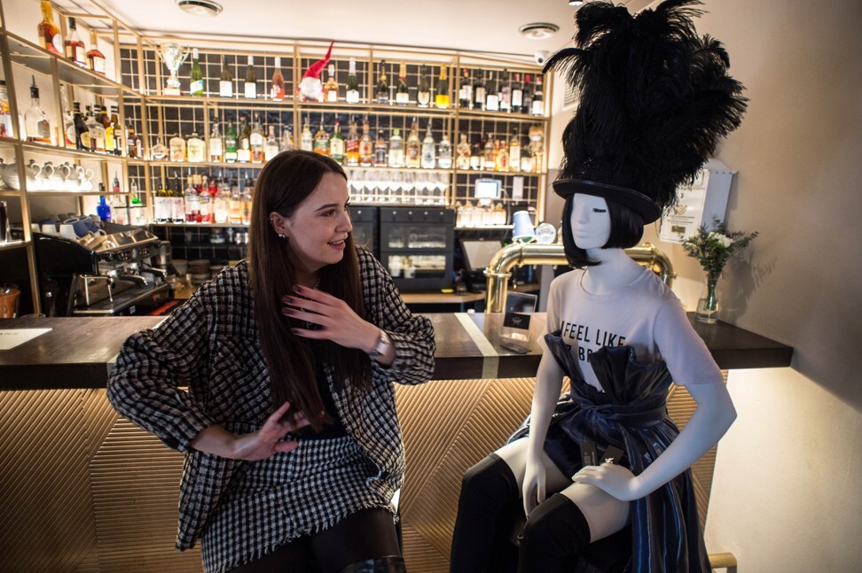 Local designer Rimante Rimgailaite sits beside a mannequin dressed in one of her creations in a restaurant in Vilnius, Lithuania. Photo: Xinhua