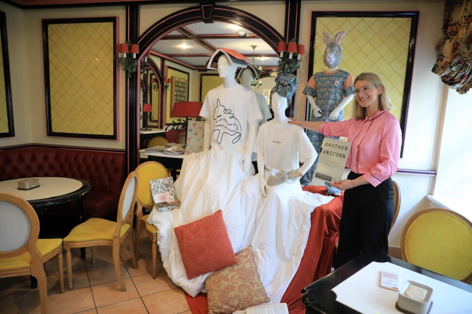 A designer from Another Unicorn boutique stands beside a mannequin used to provide social distancing at a Vilnius restaurant. Photo: AFP