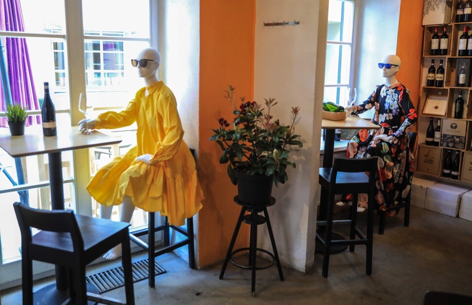 Mannequins are placed to provide social distancing at a restaurant in Vilnius. Photo: AFP