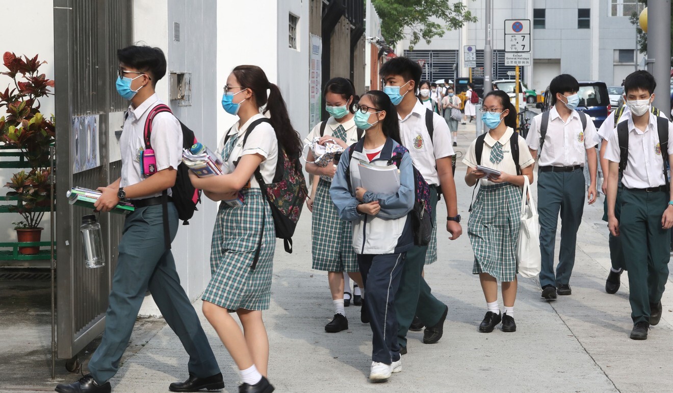 Mask-clad secondary school students return to class for the first time in months on Wednesday. Photo: Edmond So