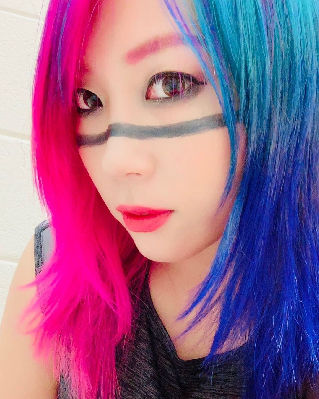 And in the pink and blue corner is WWE champ Asuka. Photo: @wwe_asuka/Instagram