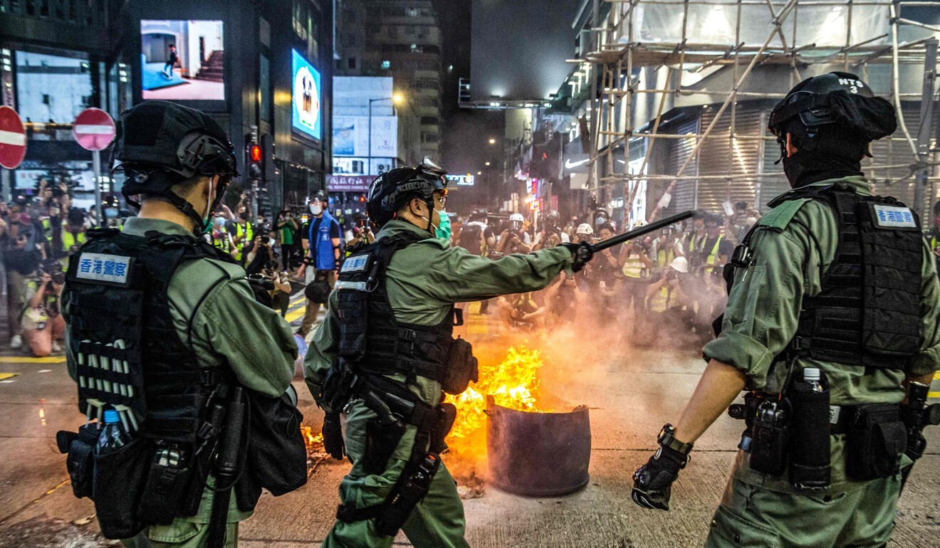 Police try to deter pro-democracy protesters from blocking roads in the Mong Kok district of Hong Kong on Wednesday. Photo: AFP