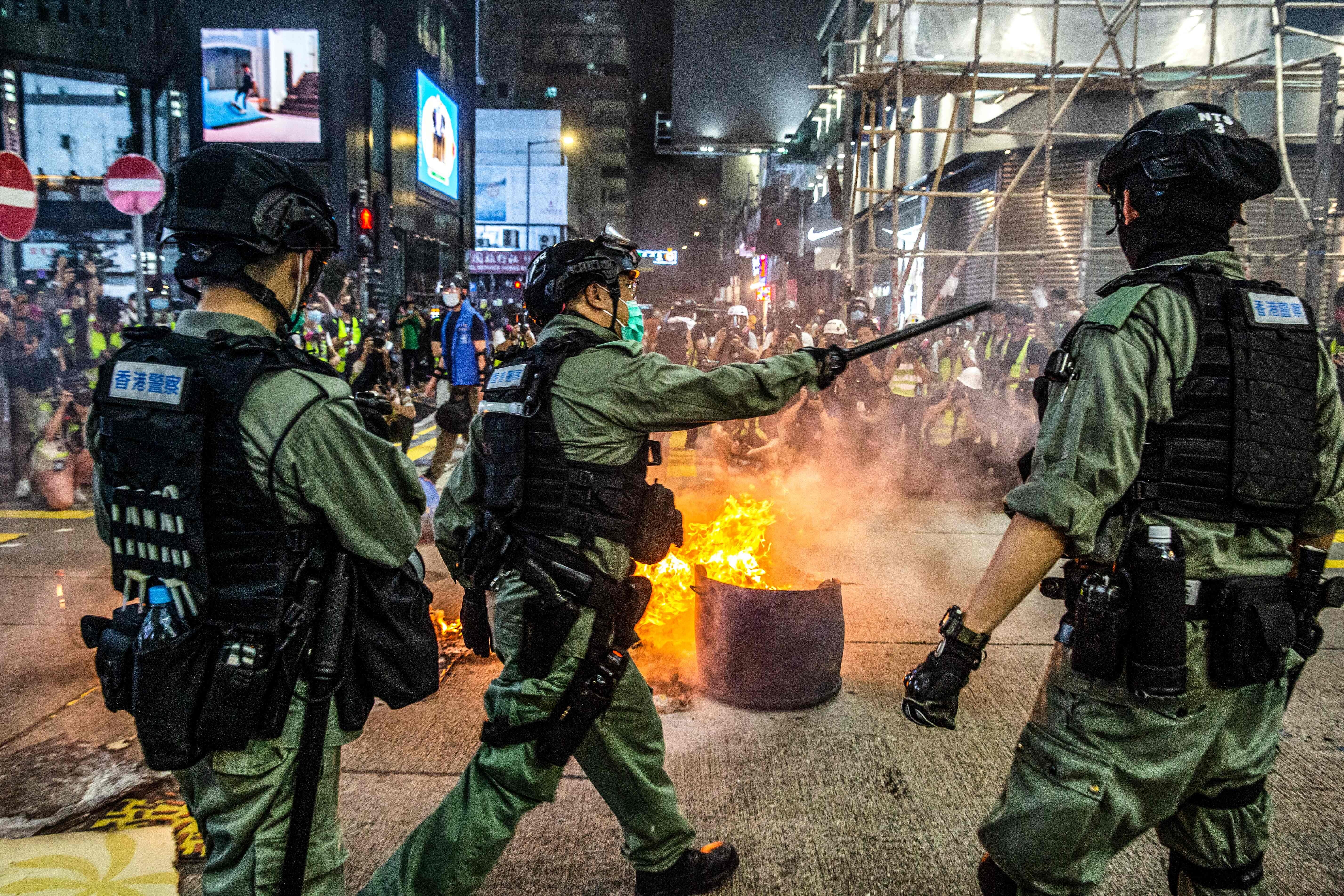 Police stand guard to deter pro-democracy protesters from blocking roads in Mong Kok on May 27. Photo: AFP