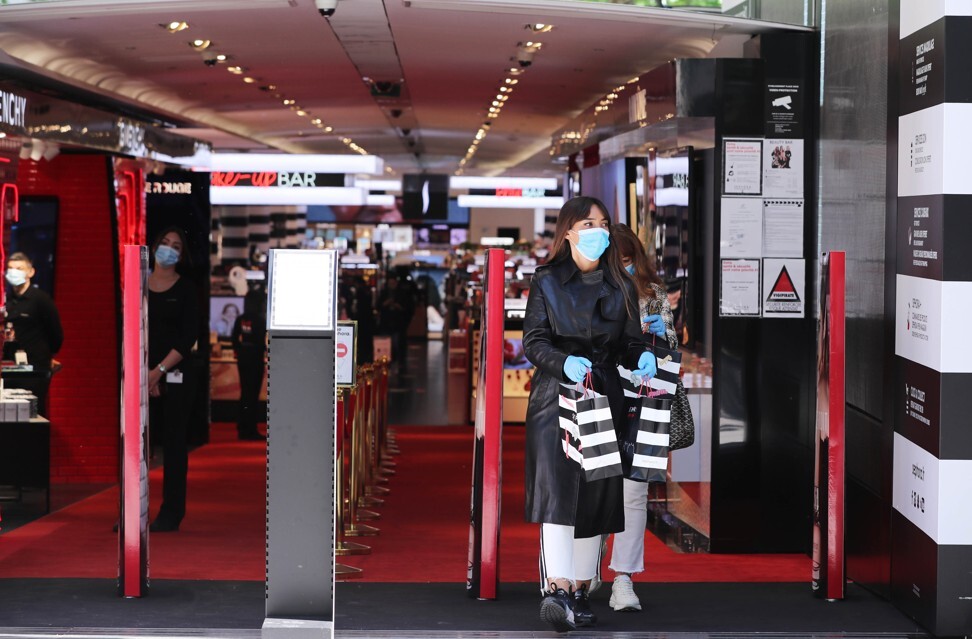 Customers wearing masks and gloves walk out of a store on the Champs-Élysées in Paris. Photo: Xinhua/Gao Jing