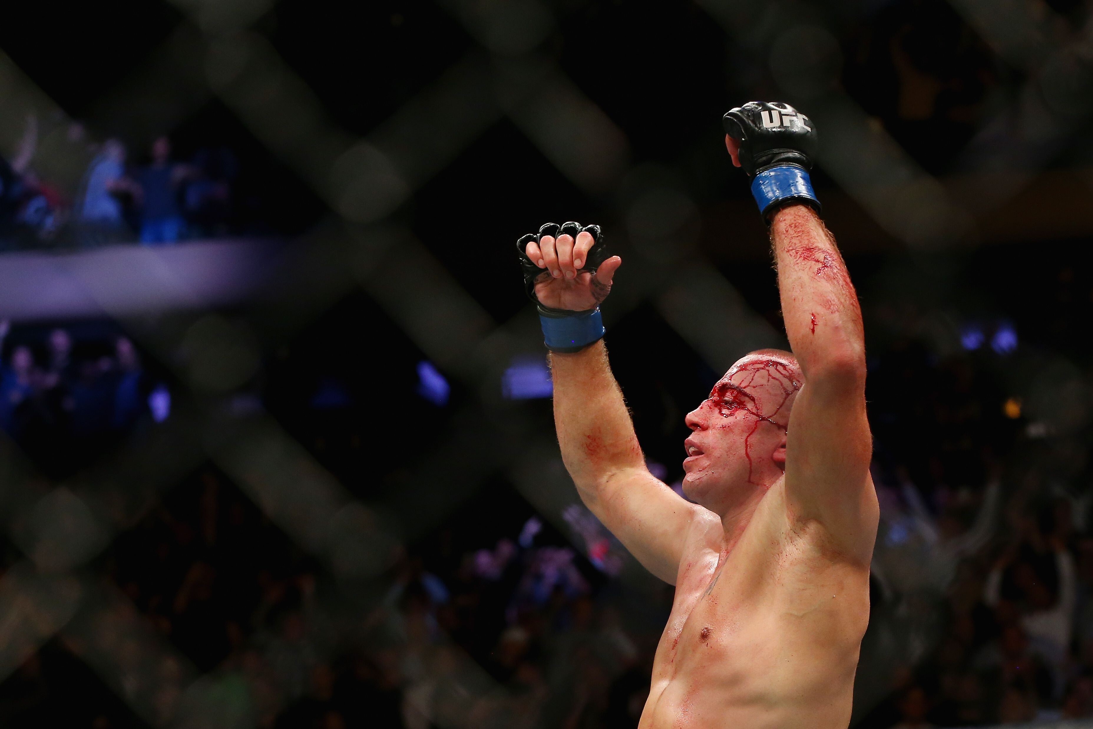 Georges St-Pierre celebrates his victory over Michael Bisping at UFC 217. Photo: AFP