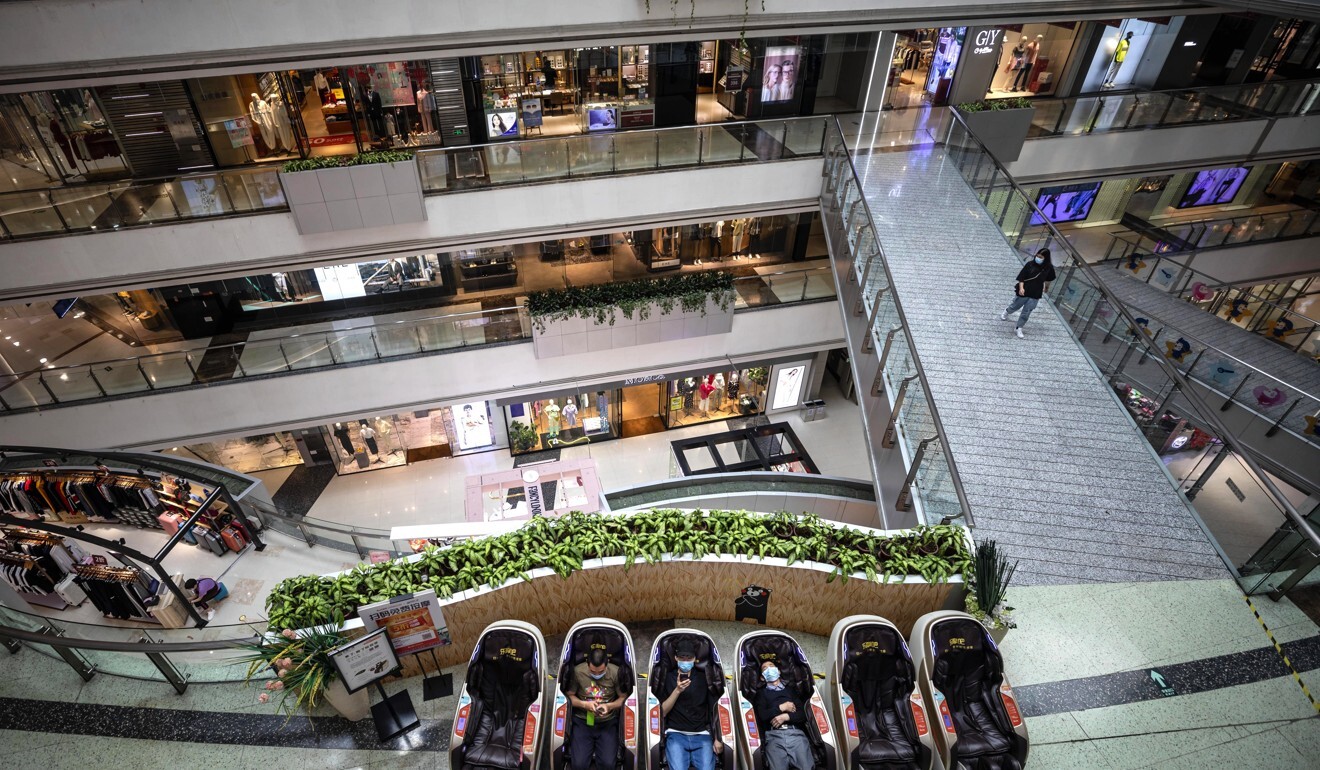 People sit in massage chairs in a near-empty shopping mall in Guangzhou, Guangdong province, China, 16 April 2020. Photo: EPA-EFE