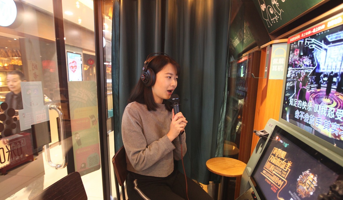 A woman sings in a mini karaoke box in a shopping mall in Beijing on Feb. 08, 2018. Photo: SCMP/Simon Song