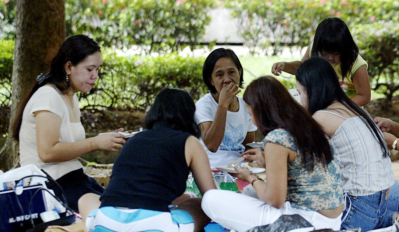 Domestic helpers enjoy a picnic in a park in Singapore in this 2003 file photo. Photo: AFP