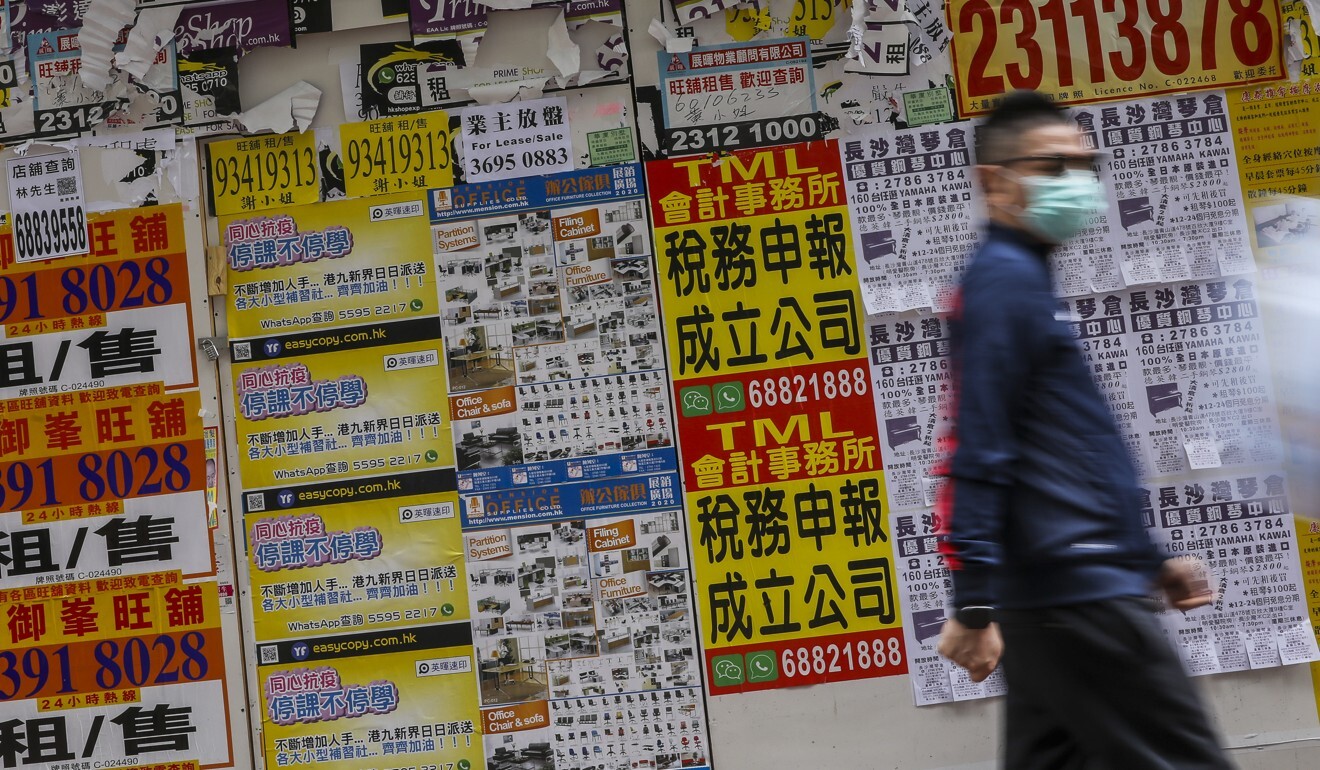 A pedestrian walks past a shuttered shop in Mong Kok. Photo: K.Y. Cheng