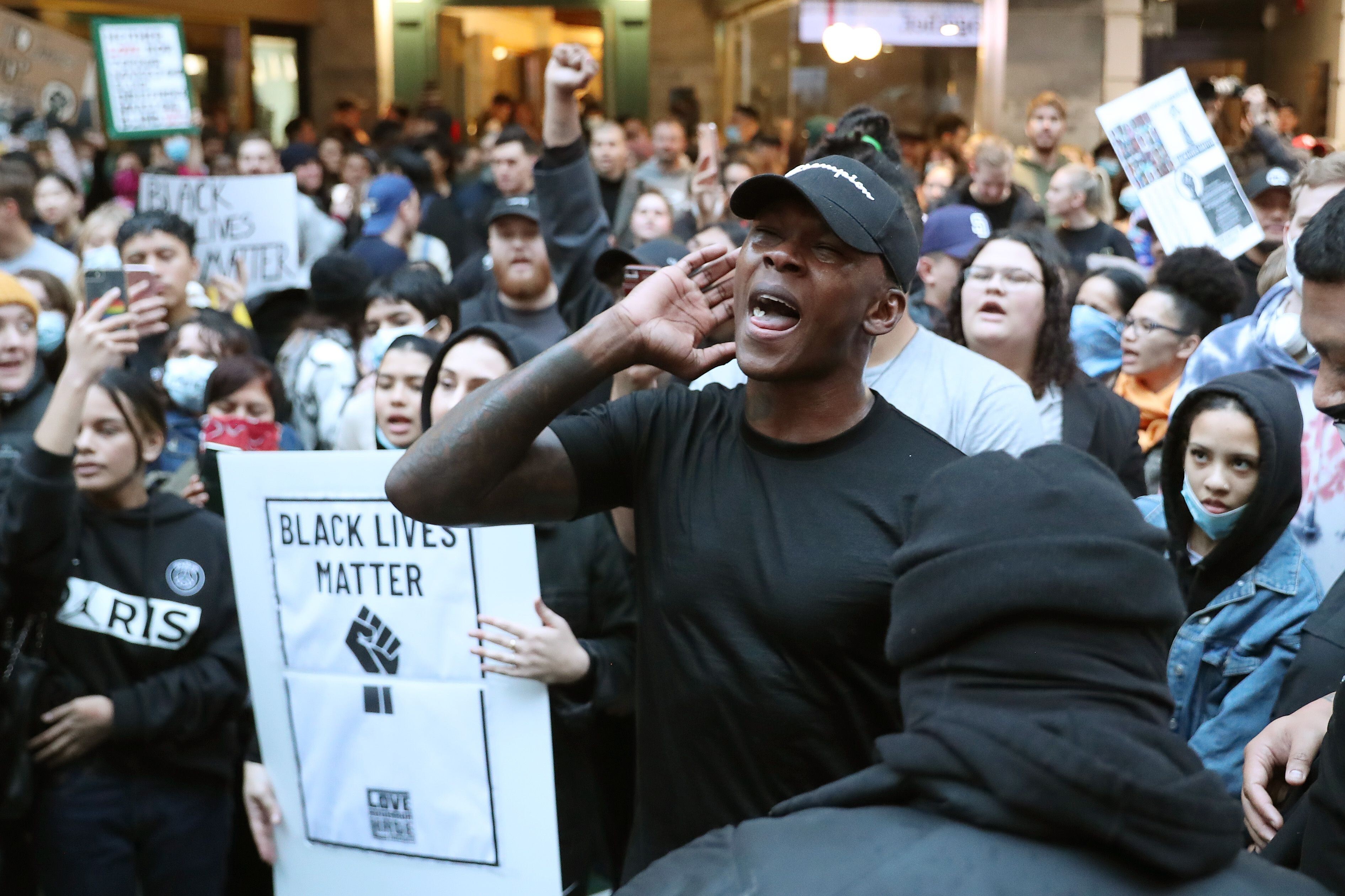 UFC middleweight champion Israel Adesanya joins roughly 4,000 New Zealand protesters demonstrating against the killing of Minneapolis man George Floyd in a Black Lives Matter protest in Auckland in June. (Photo: AFP